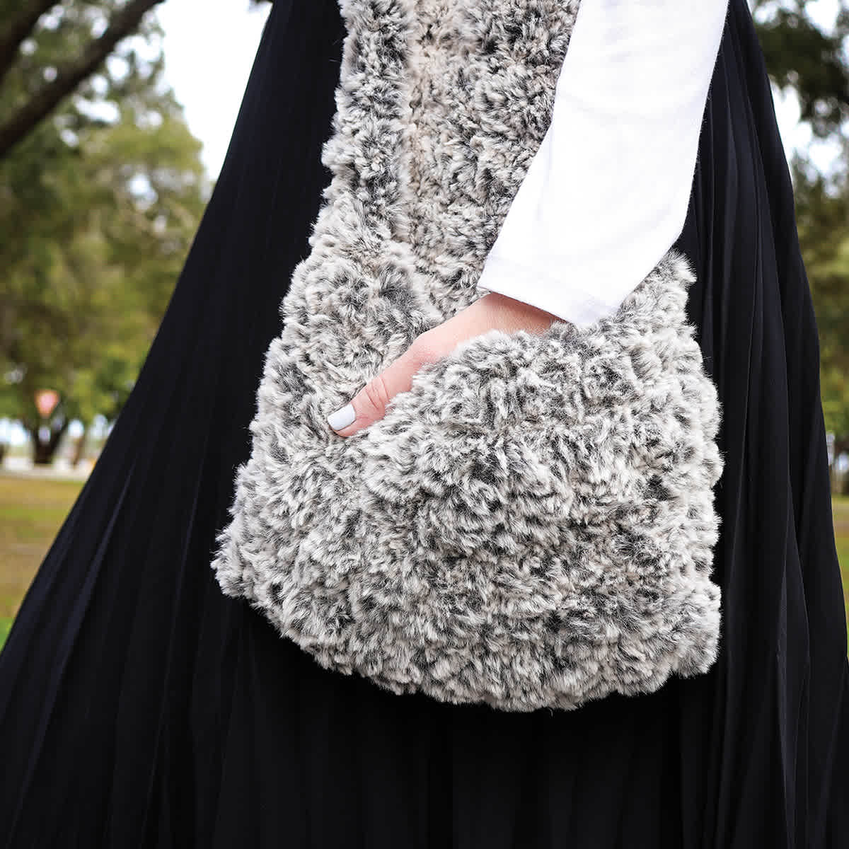 Lion Brand Go For Faux Thick And Quick Yarn - Side view of model carrying finished Knit Bag