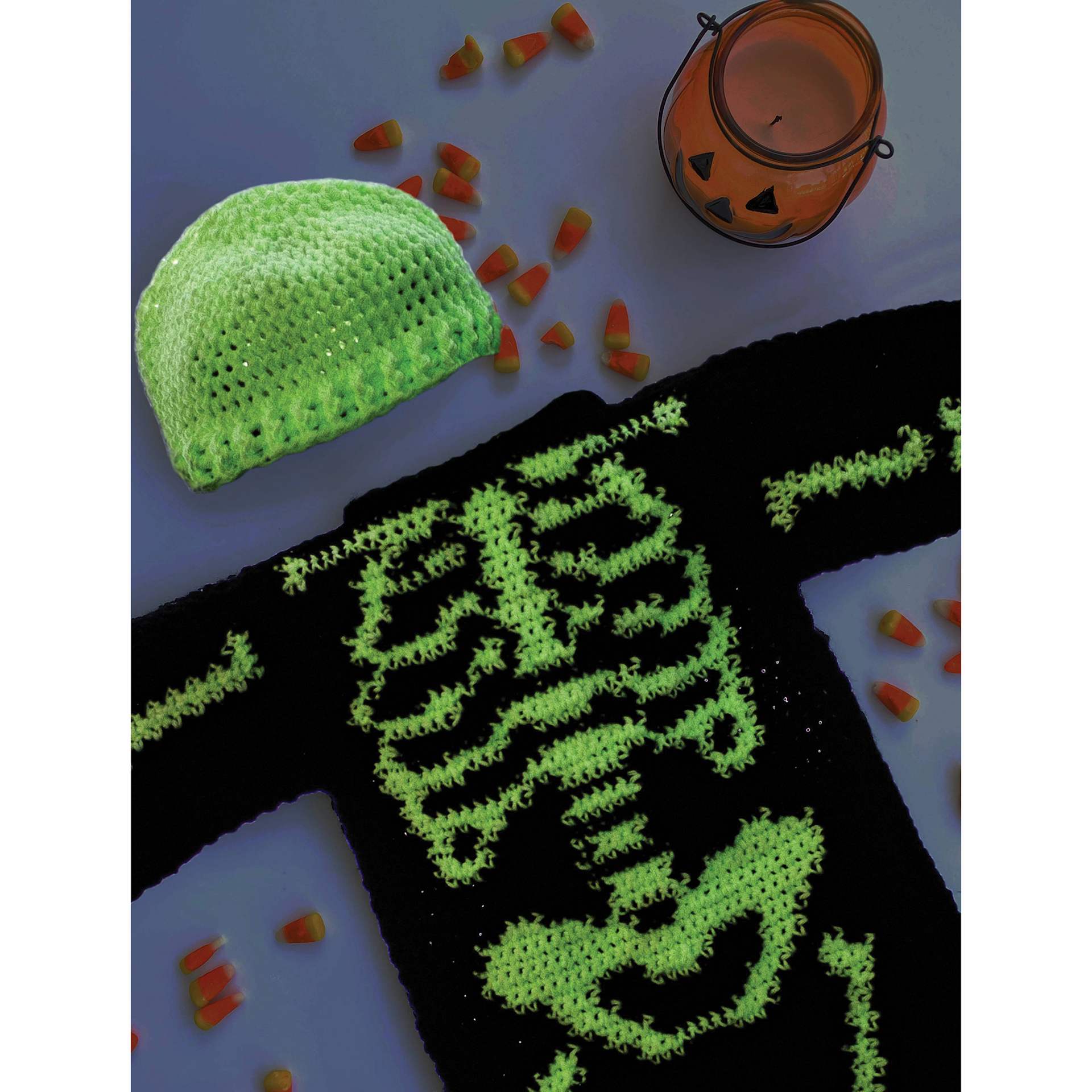 Lion Brand DIY Glow Yarn - laid beanie and skeleton-themed sweater with bones and glowing