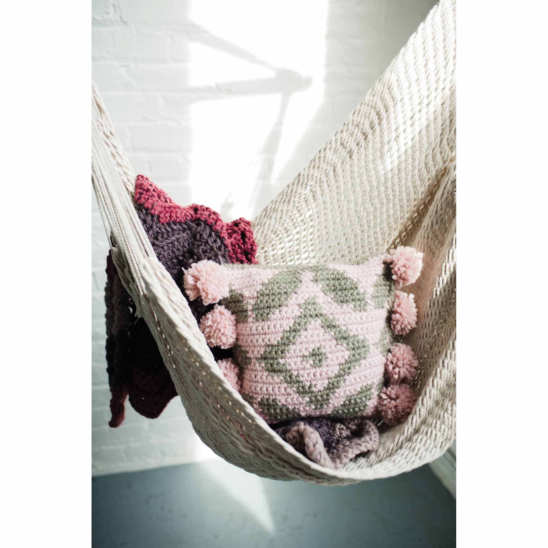 Lion Brand Re-Spun Thick & Quick Yarn - finished pillow and blanket example on hammock