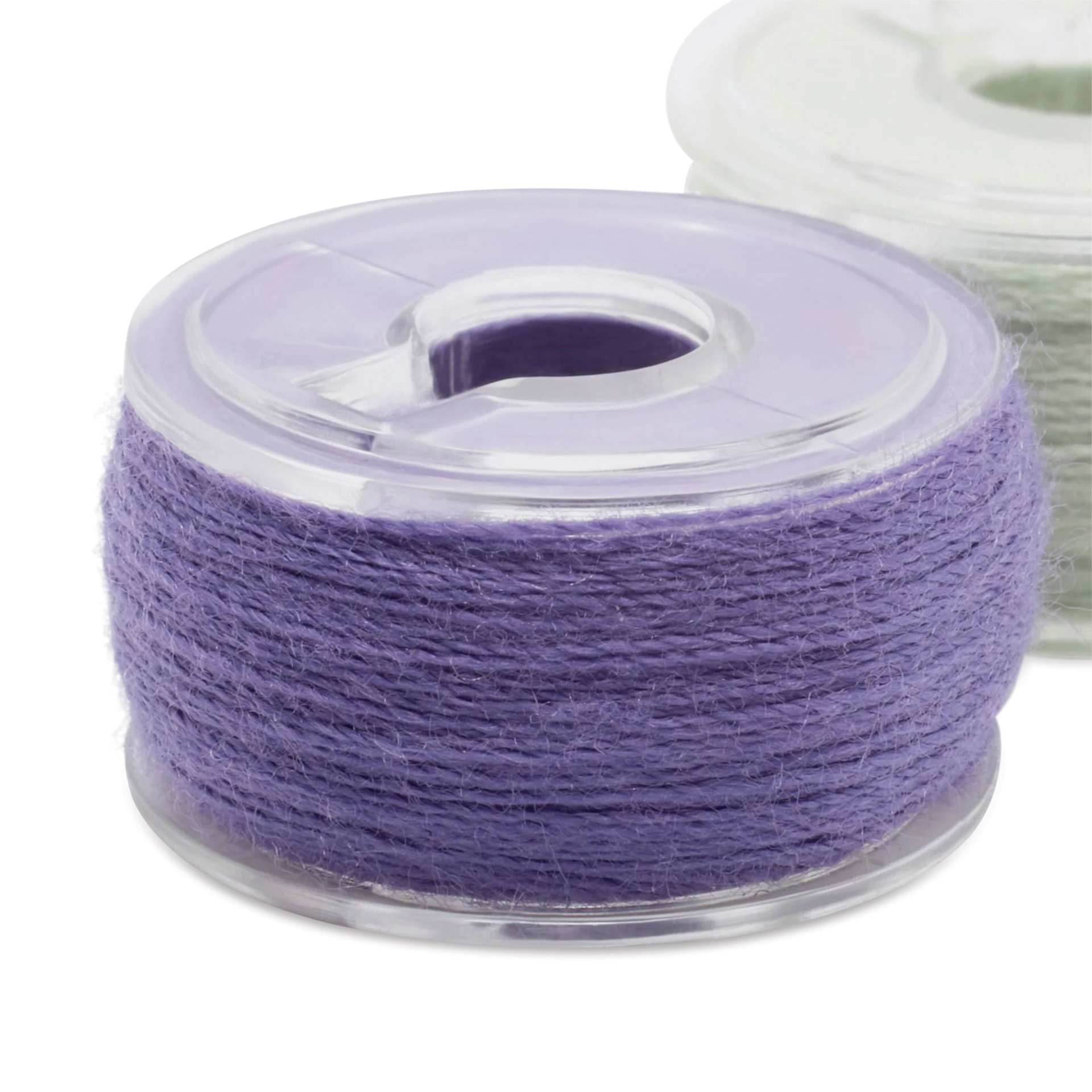 Dritz Class 15 Pre-Wound Reusable Bobbins - Set of 12, 50 yds close up of single bobbin