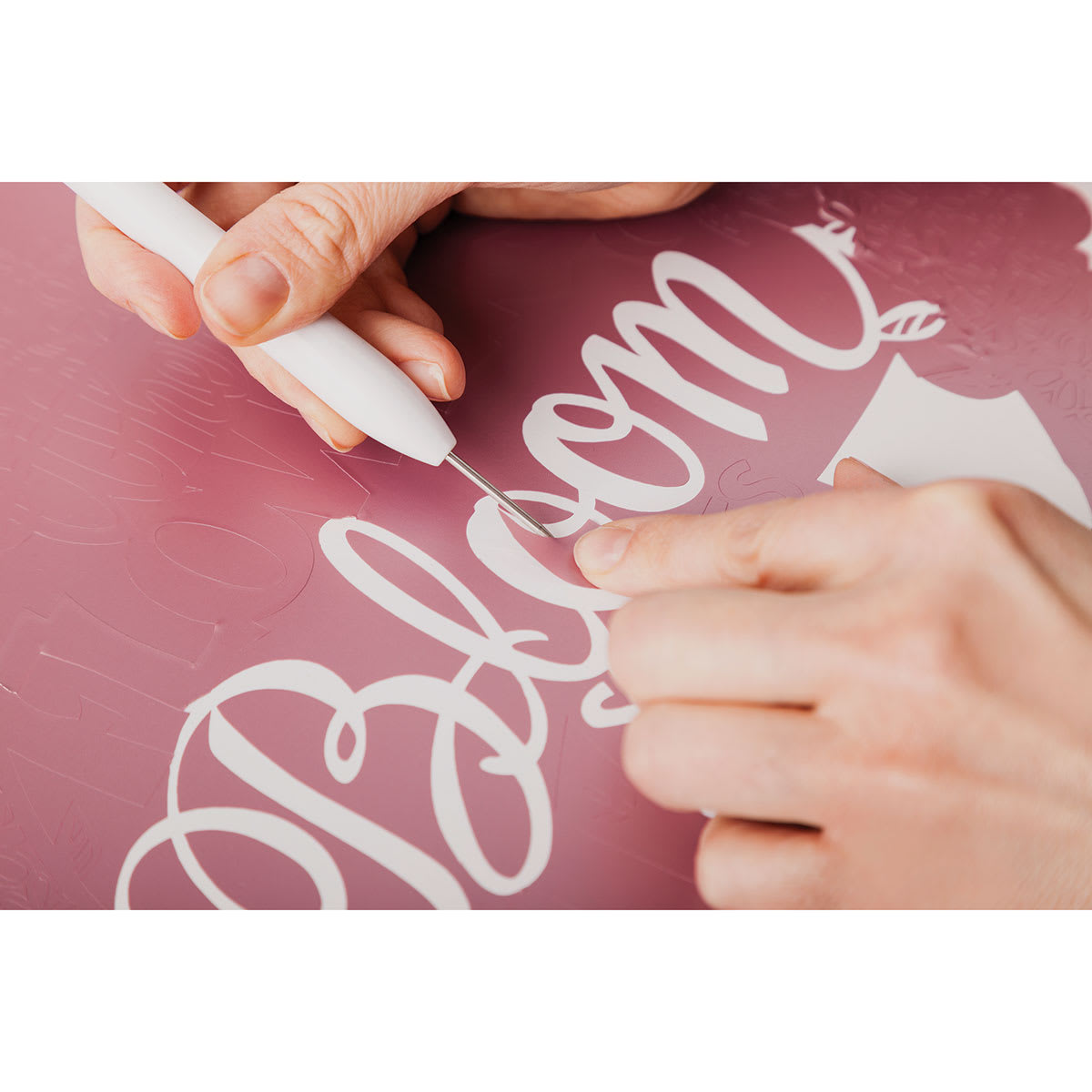 Cricut Weeding Tool Kit - Closeup of artist using piercing tool on vinyl sign
