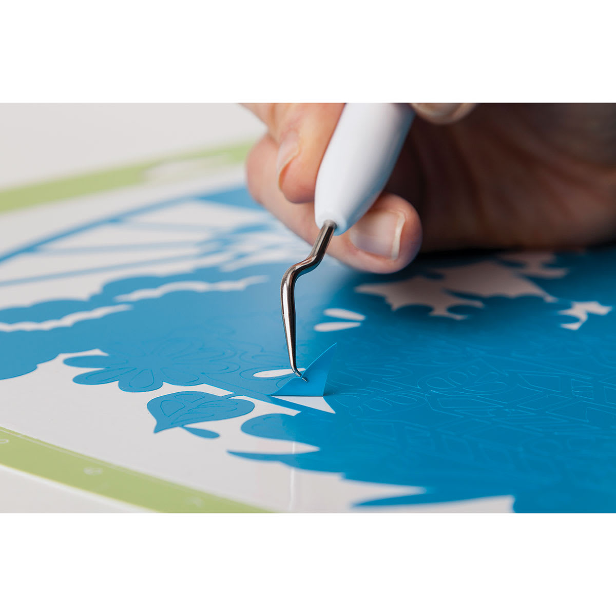 Cricut Weeding Tool Kit - Closeup of Angle Tip Weeder cutting blue vinyl
