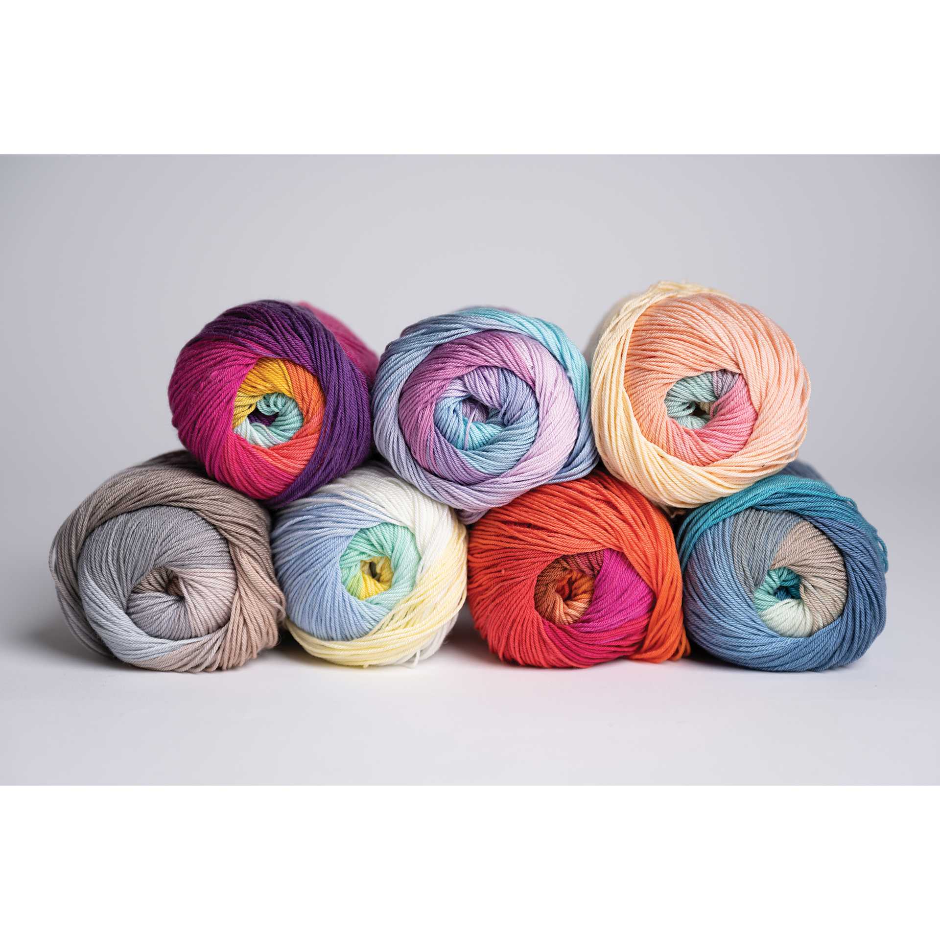Lion Brand Mandala String Yarn - partial pyramid of seven skeins