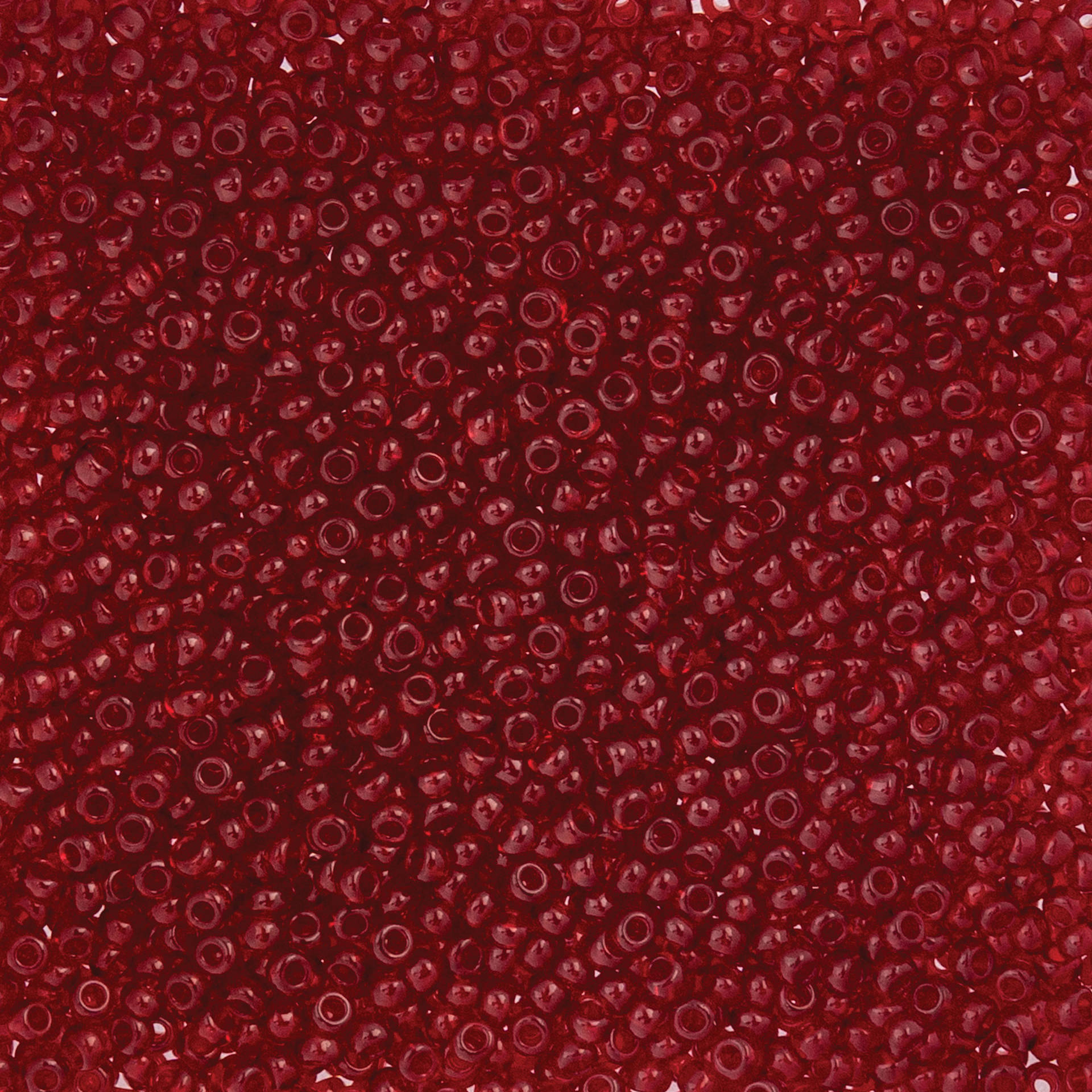 John Bead Czech Glass Seed Beads - Transparent Dark Red, 10/0, 22 g Vial close up