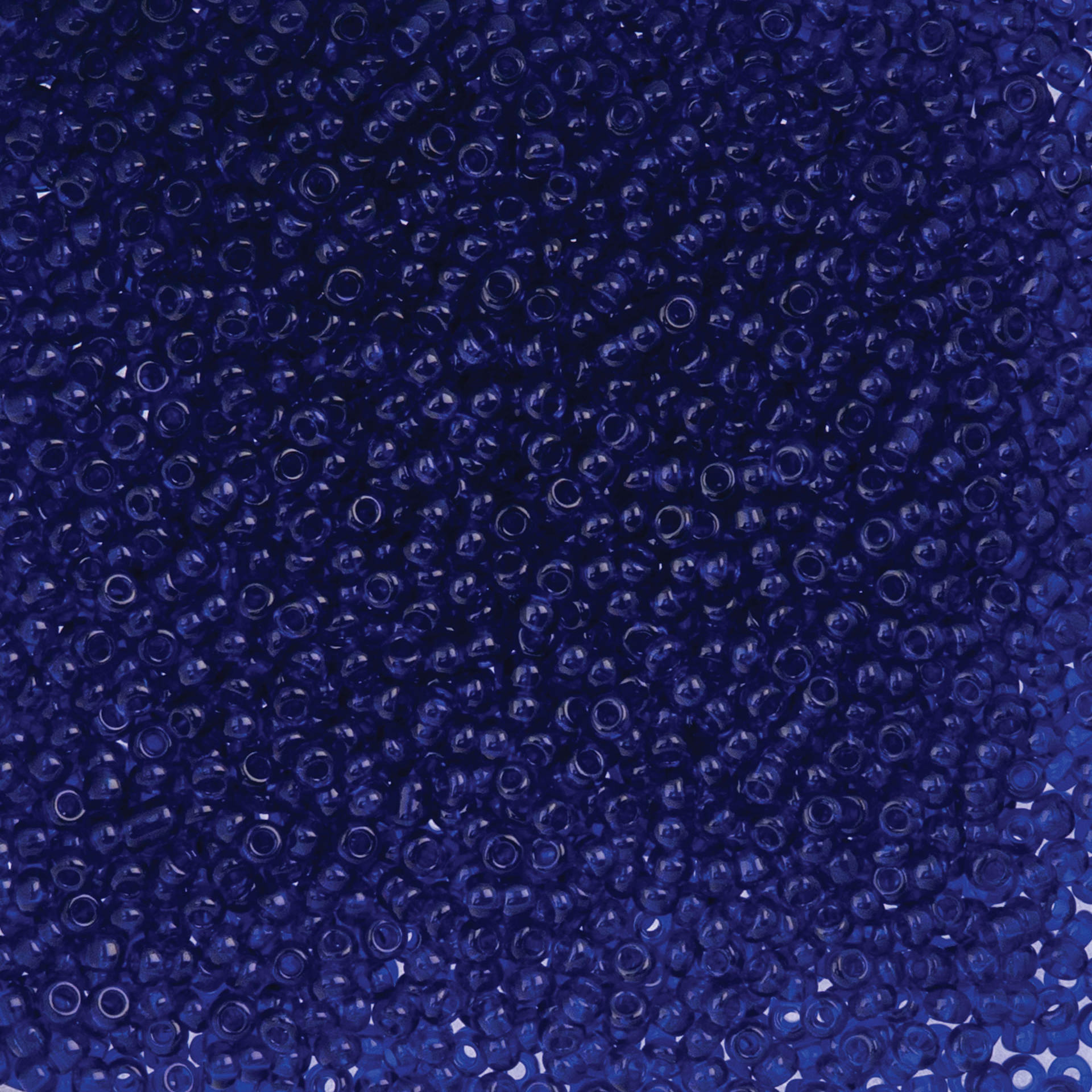 John Bead Czech Glass Seed Beads - Transparent Royal Blue, 10/0, 22 g Vial close up