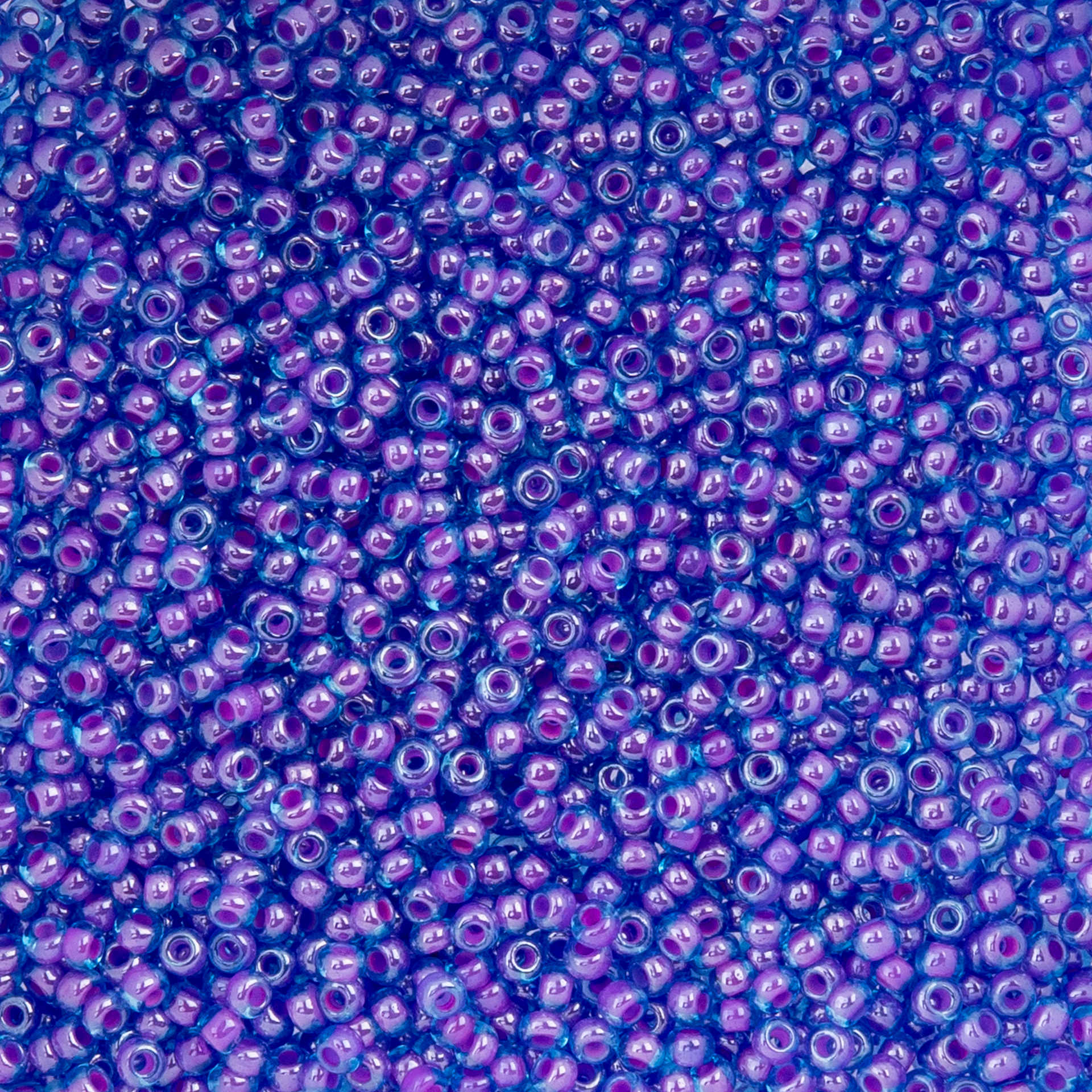John Bead Czech Glass Seed Beads - Color-Lined Fuchsia and Transparent Blue, 10/0, 22 g Vial close up
