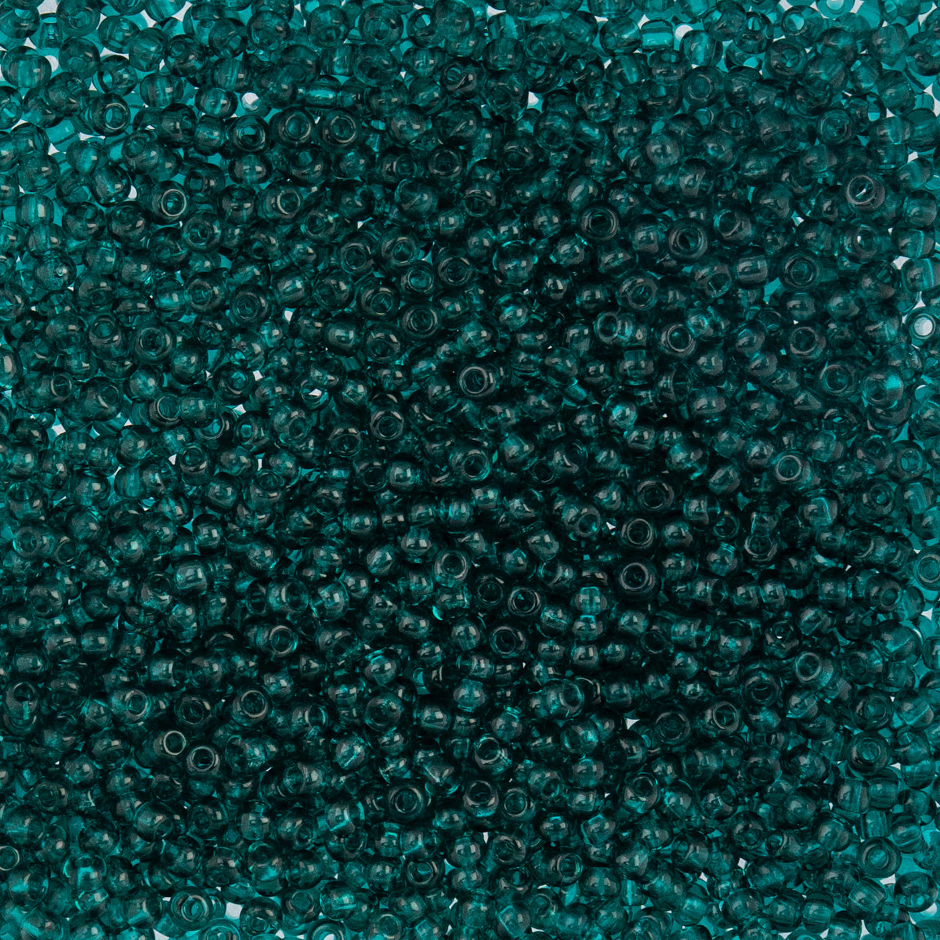 John Bead Czech Glass Seed Beads - Transparent Teal, 10/0, 22 g Vial close up