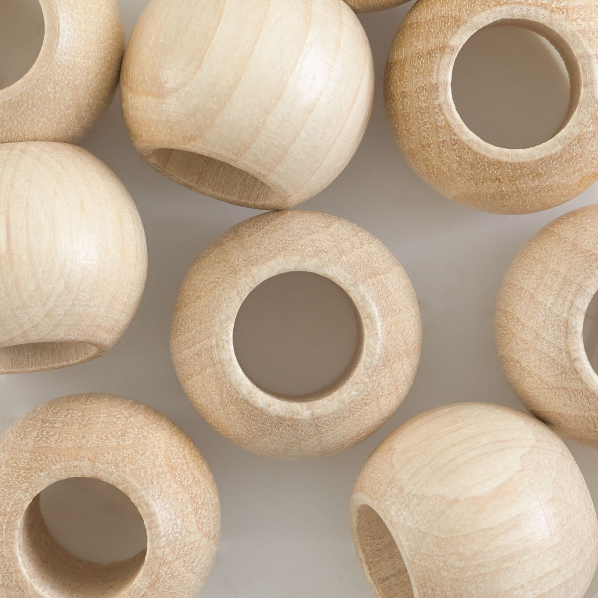 John Bead Euro Wood Beads - Natural, Round Large Hole, 20 mm x 16 mm - close-up of beads
