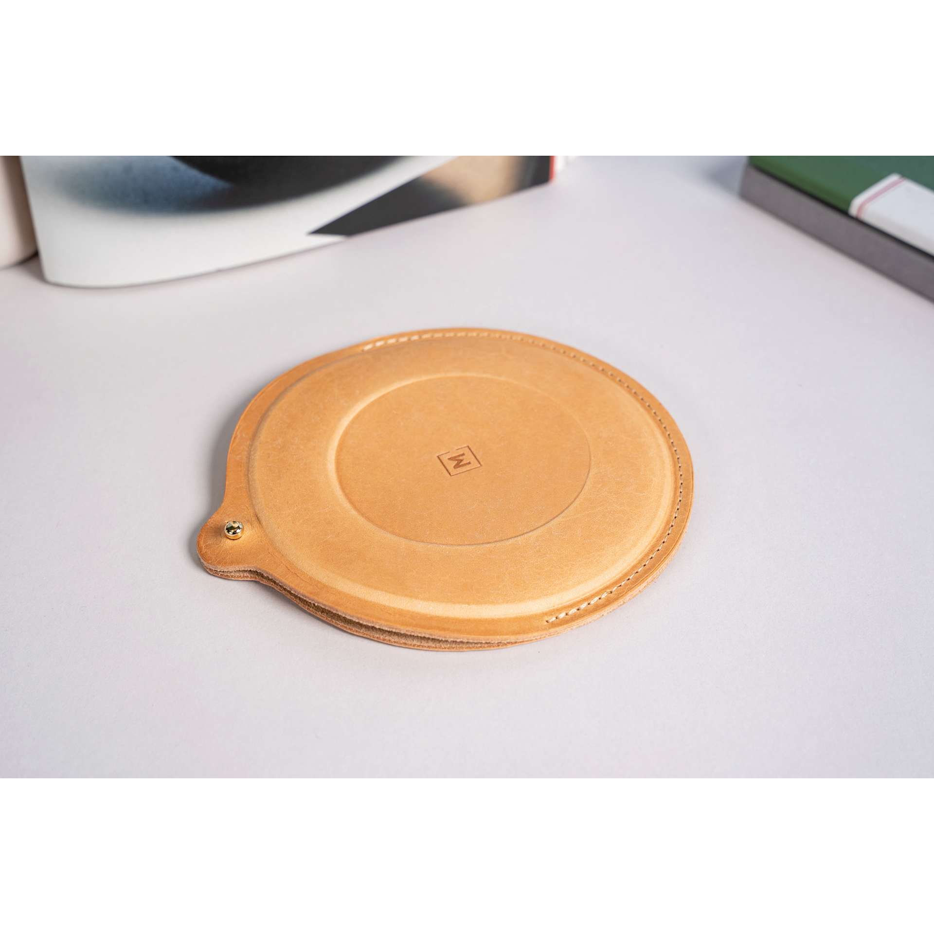 Makers Cabinet Leather Iris Sheath - 5" Diameter, resting on tabletop