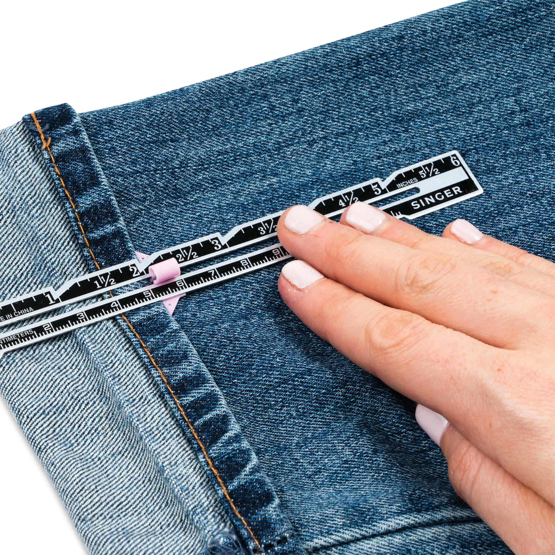 Singer Hemming Kit, close-up of the seam gauge held on top of hem
