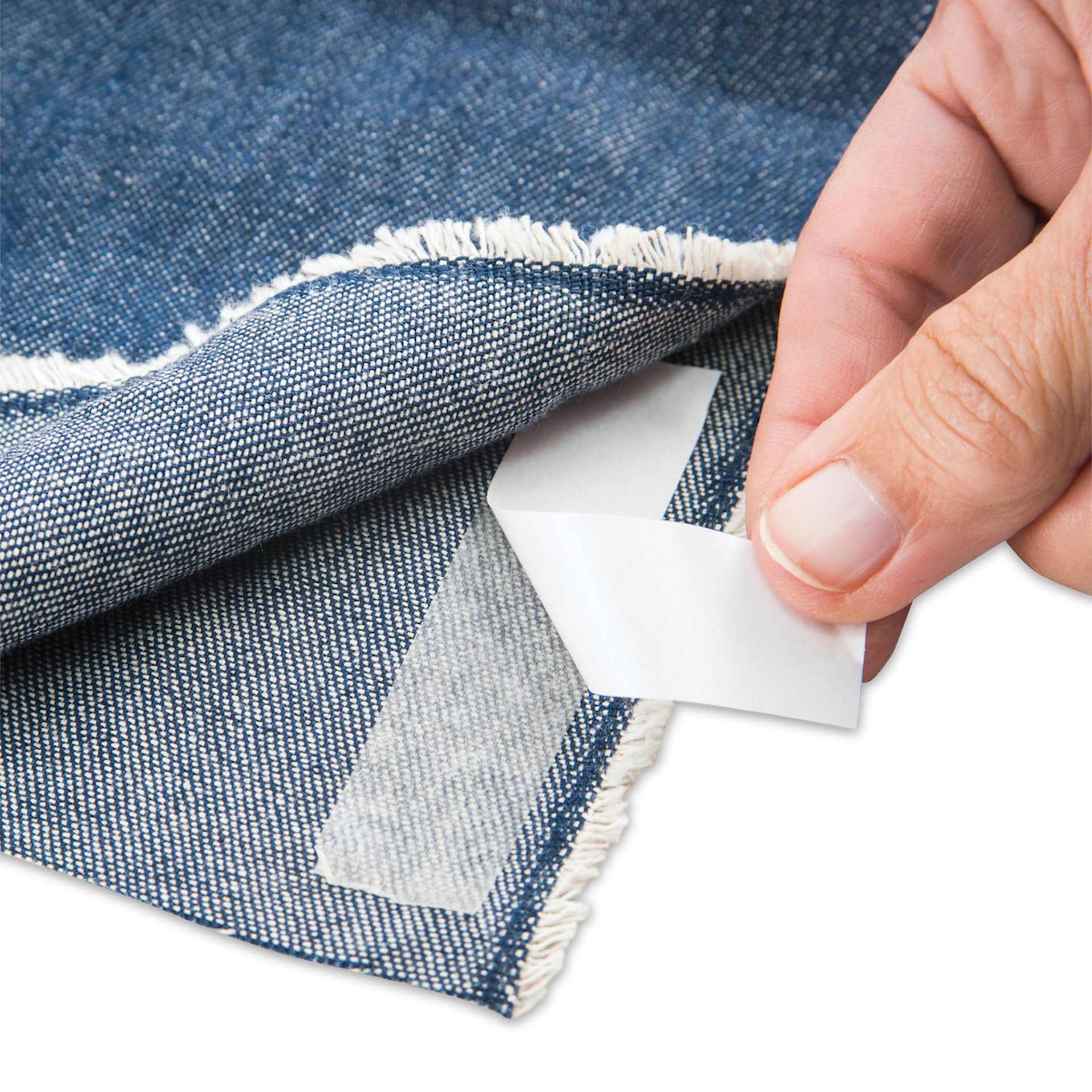 Singer Hemming Kit, hand peeling tape revealing adhesive