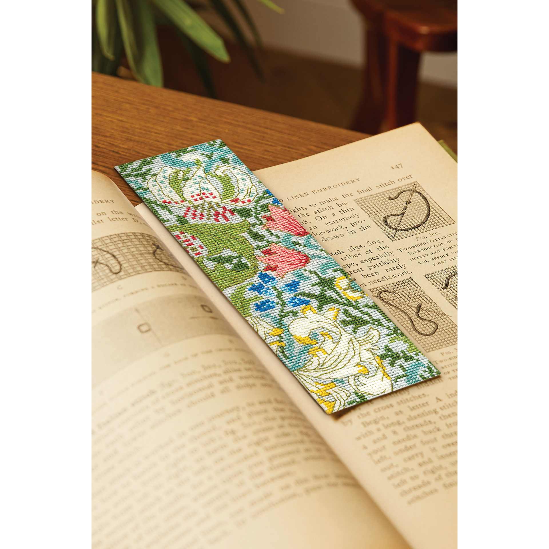 DMC The Masters Collection Cross Stitch Bookmark Kit - "Golden Lily" by J.H. Dearle in a book