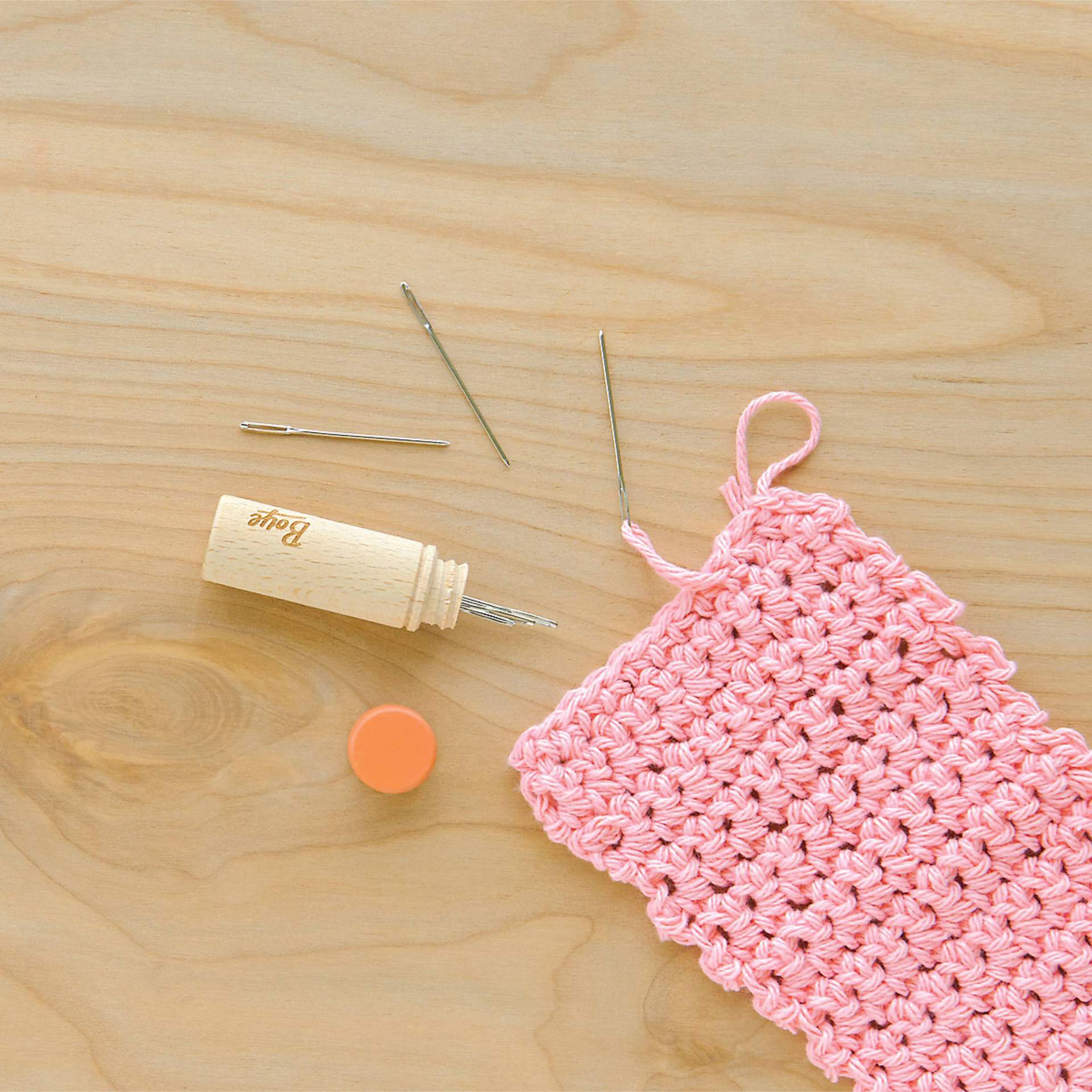 Boye Wood Container & Yarn Needles - Pkg of 6 Needles, Coral Lid - in use, next to pink knitting example