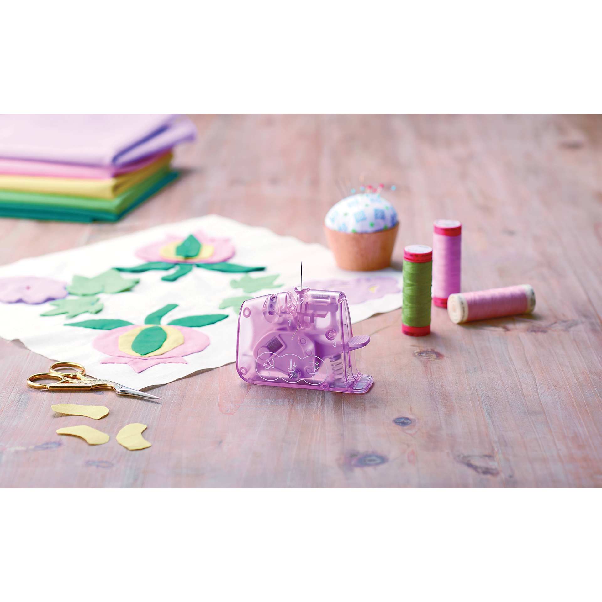 Clover Quick Desktop Needle Threader - Dark Pink - on table