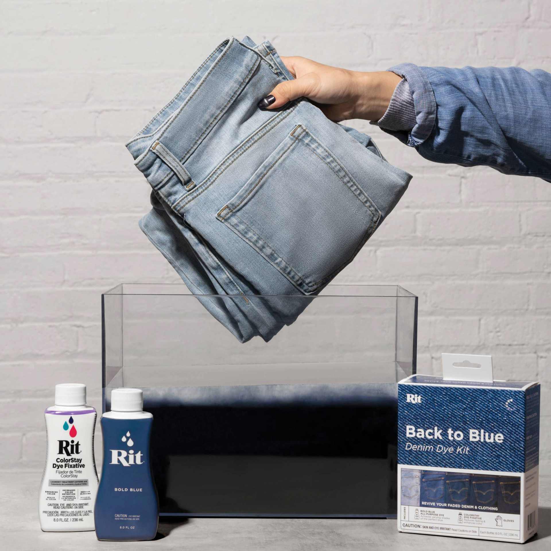 Rit Back to Blue Denim Dye Kit - lifting jeans out of dye tub