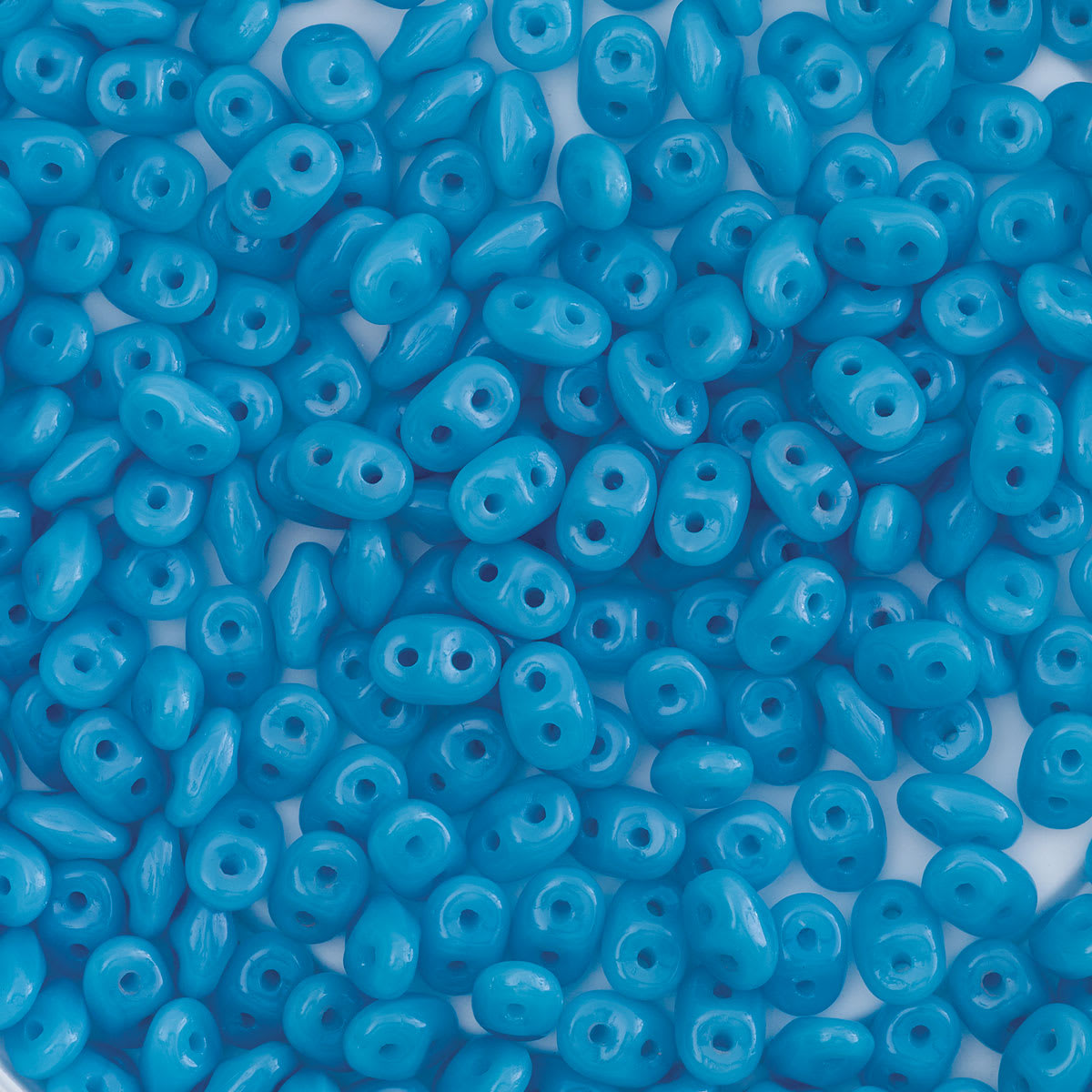 John Bead Czech Glass SuperDuo Two-Hole Beads - Pile of Blue Turquoise beads shown
