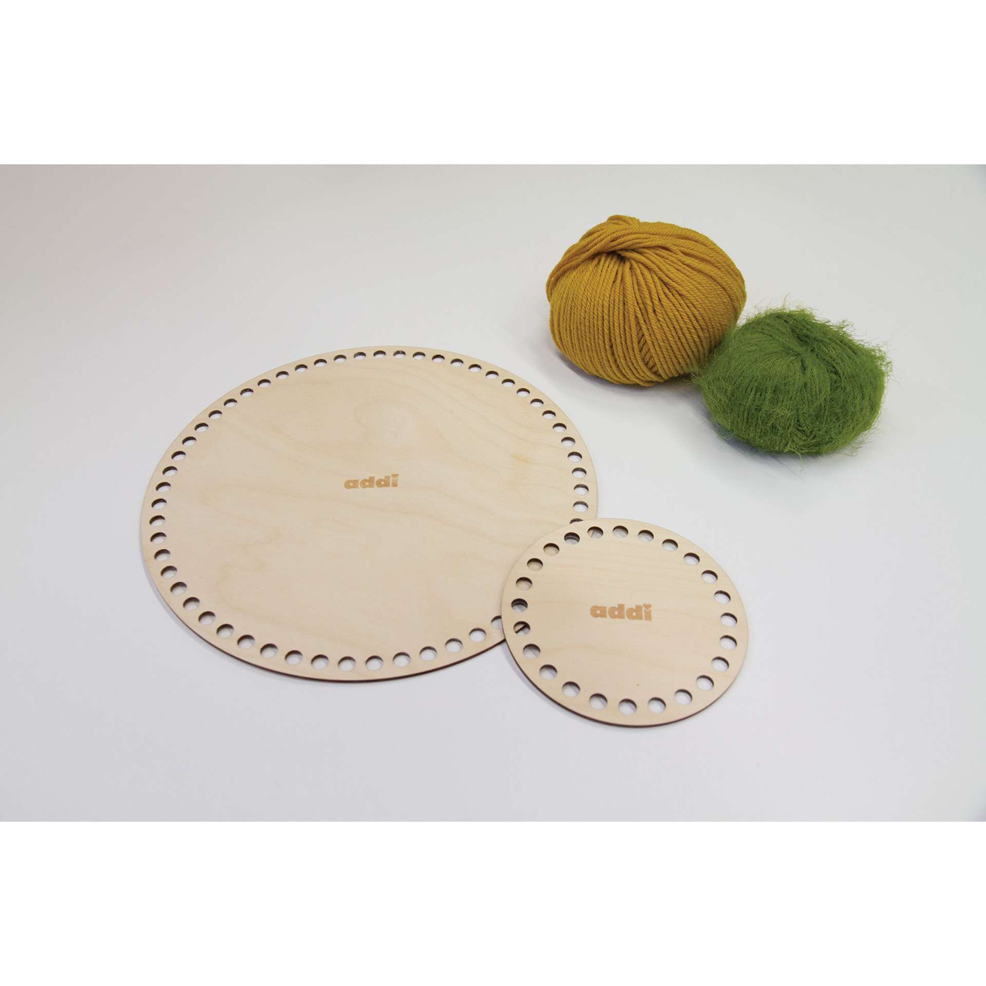 Skacel by Addi Shapes Basket Bases - Pkg of 2, Circle sitting beside yarn
