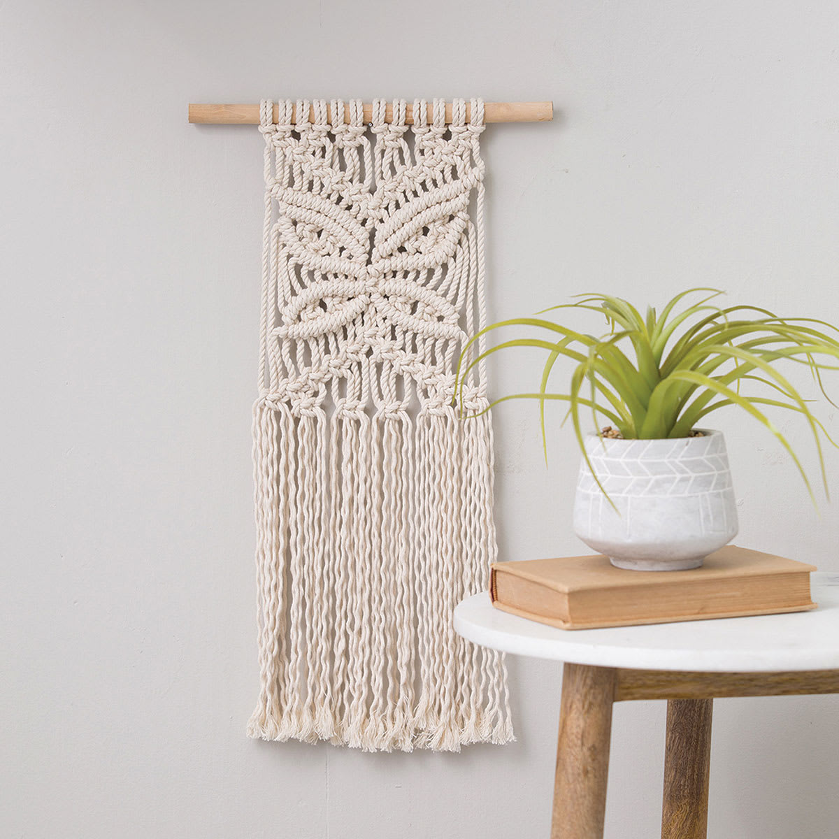 Leisure Arts Macramé Butterfly Kit (Completed macramé butterfly hanging on wall)