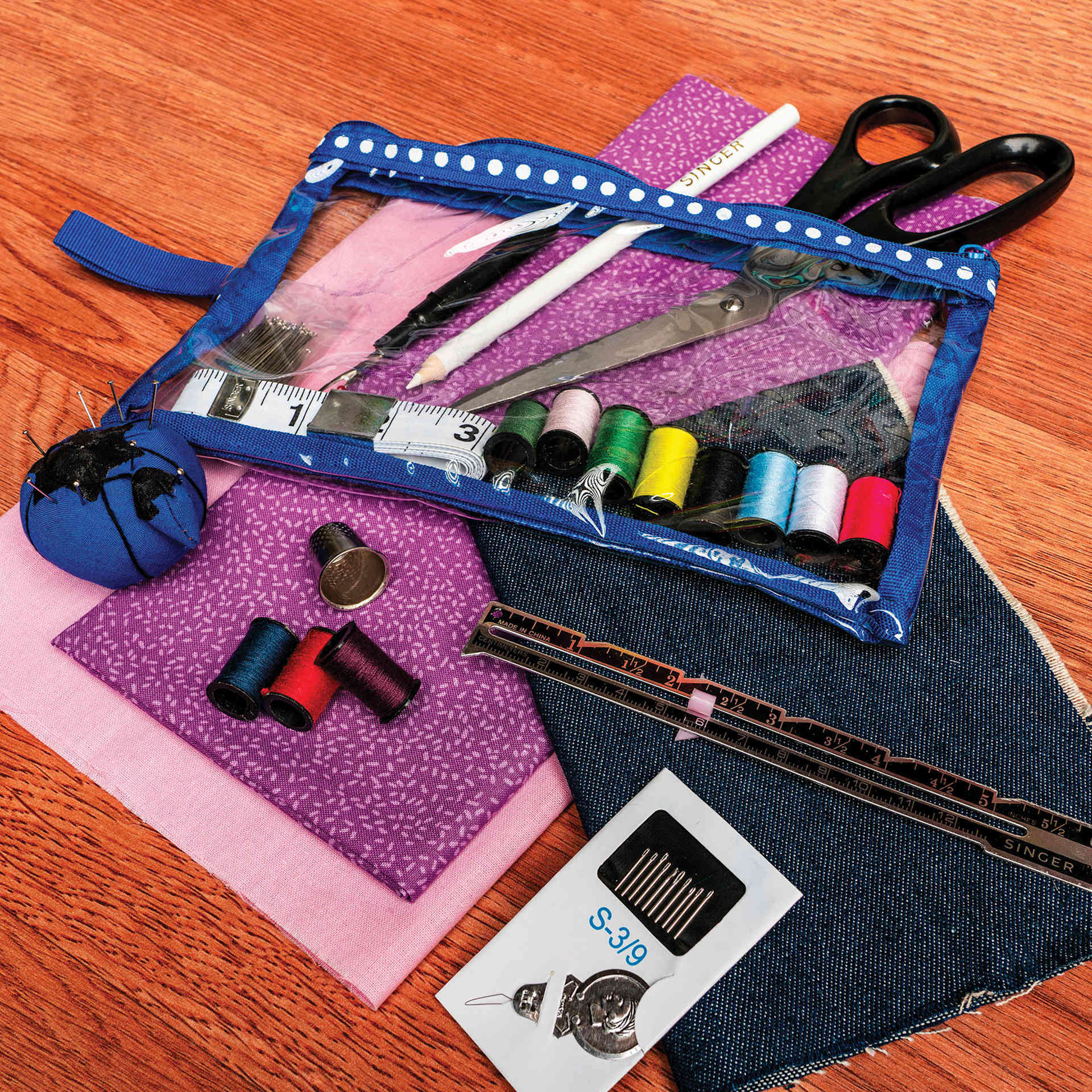 Singer Beginner's Deluxe Sewing Kit pouch and contents with fabric (not included)