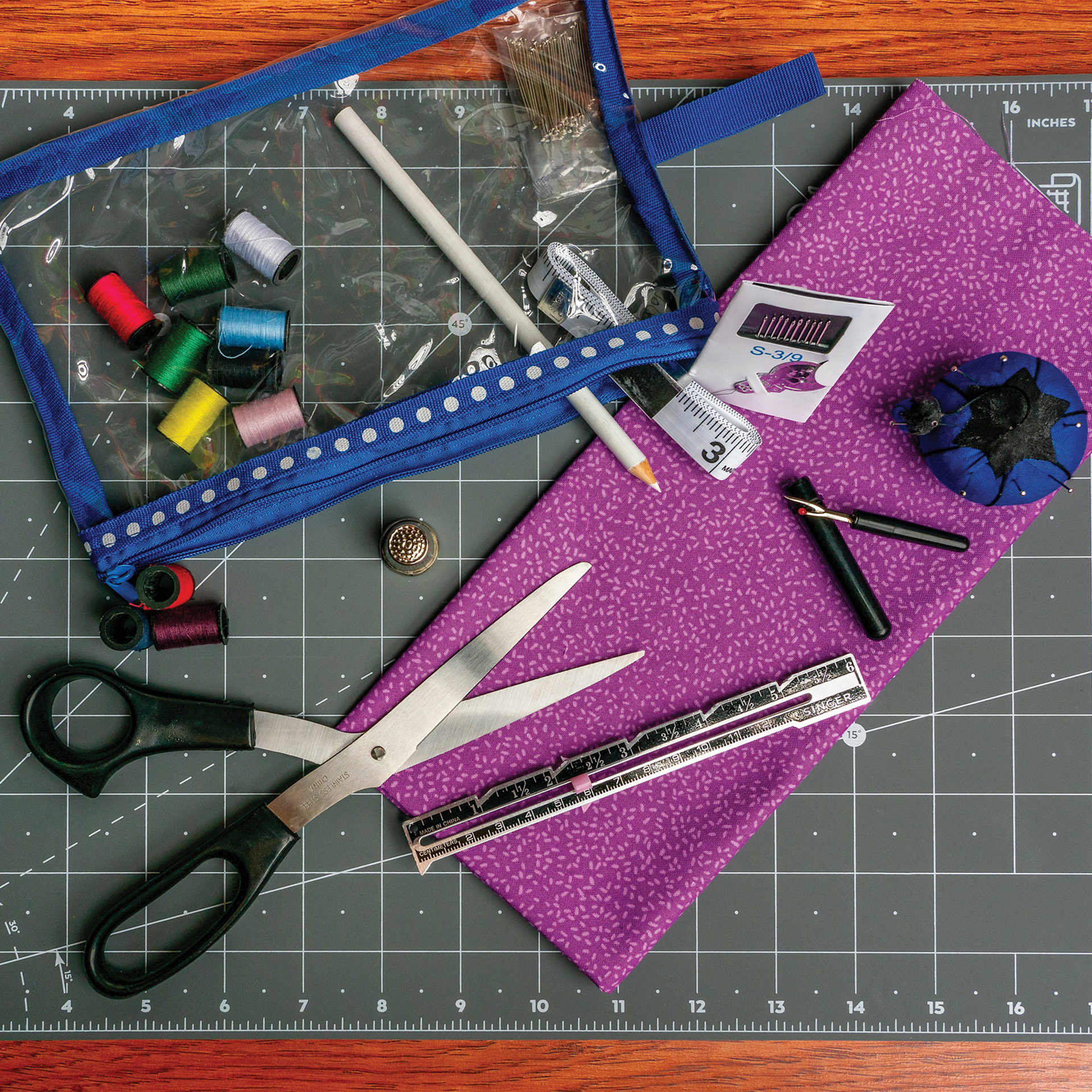 Singer Beginner's Deluxe Sewing Kit contents and pouch on top of cutting mat
