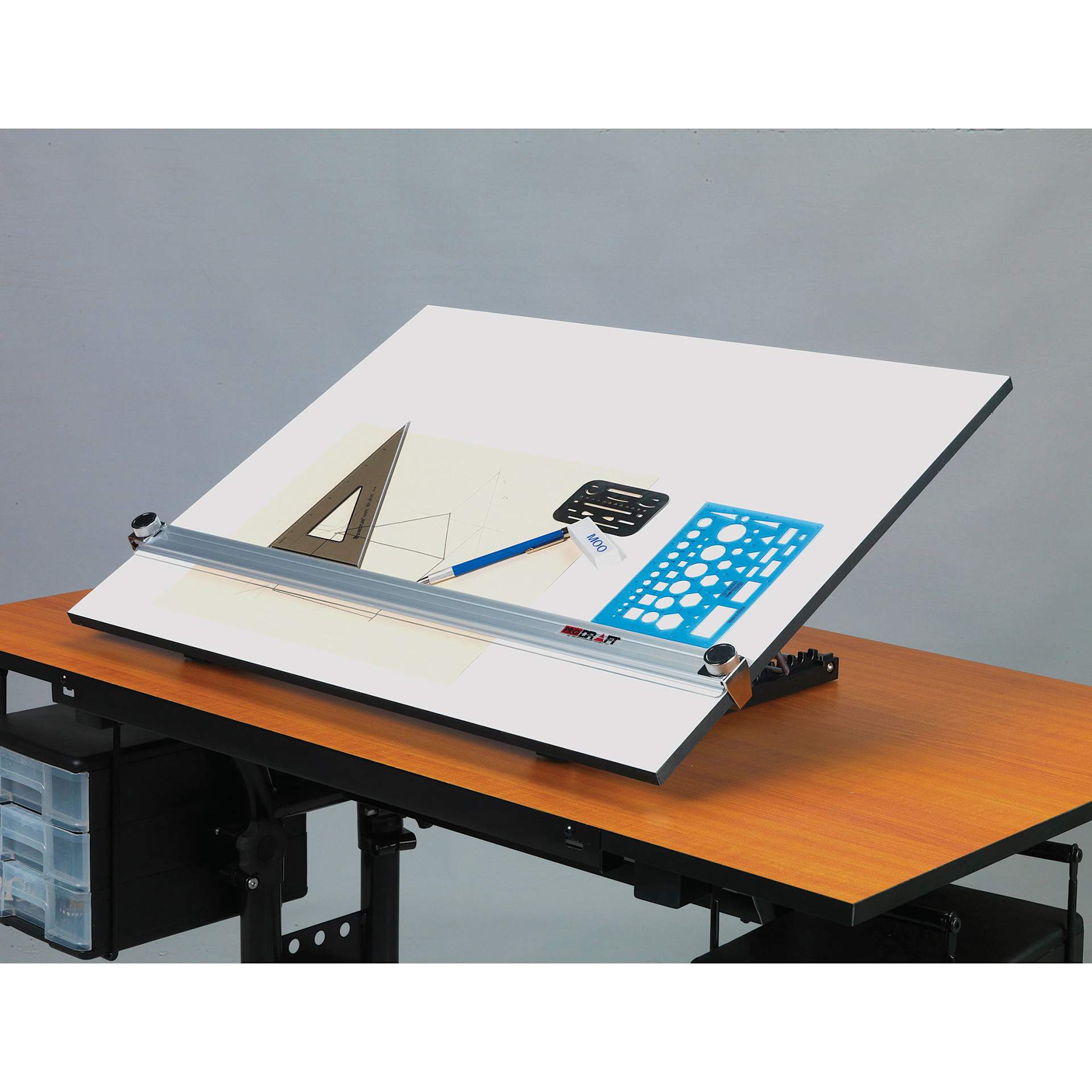 Pro-Draft Deluxe Parallel Straightedge Drawing Board, tilted on a table with drawing tools on top