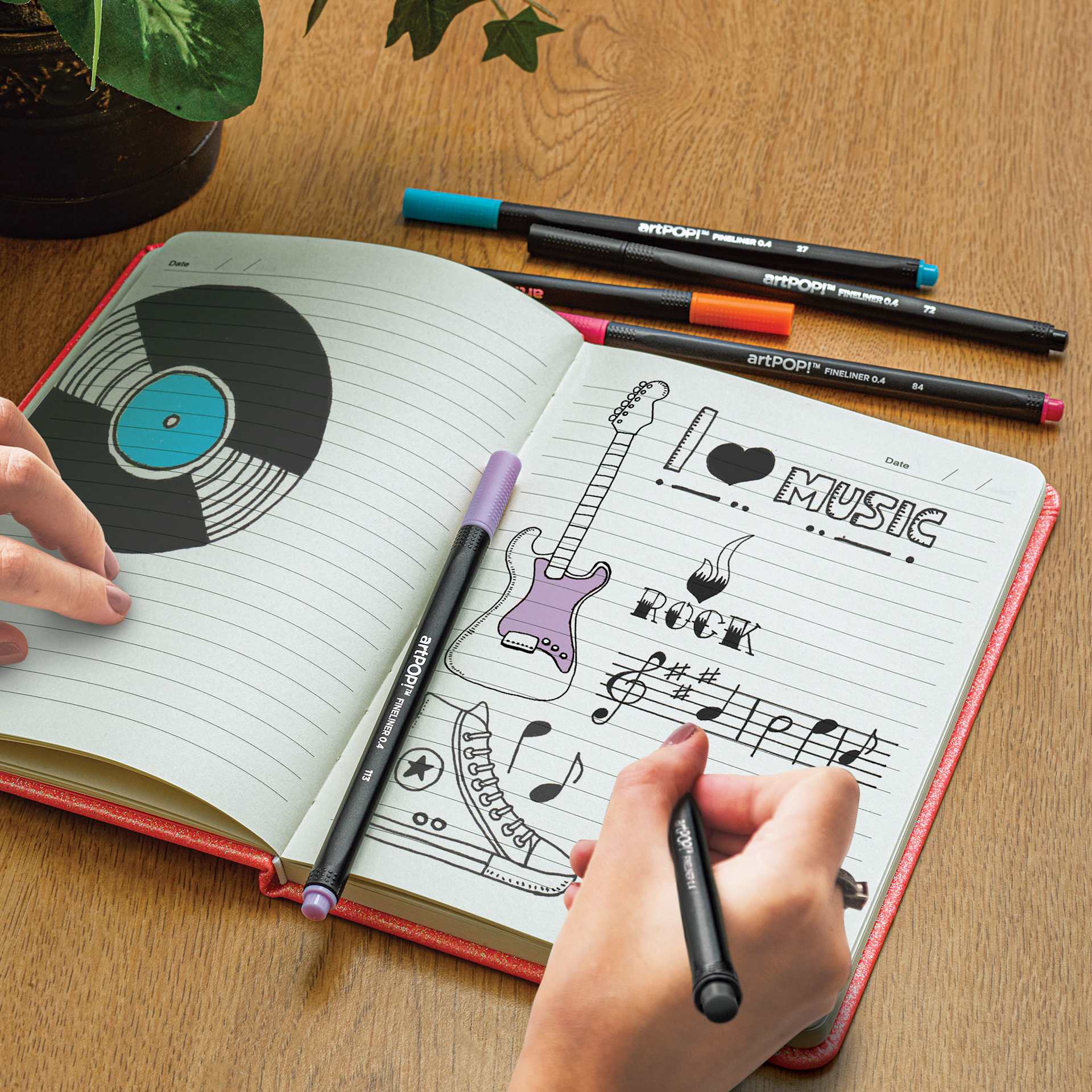 artPOP! Rainbow Hardcover Notebook (person sketching in notebook)