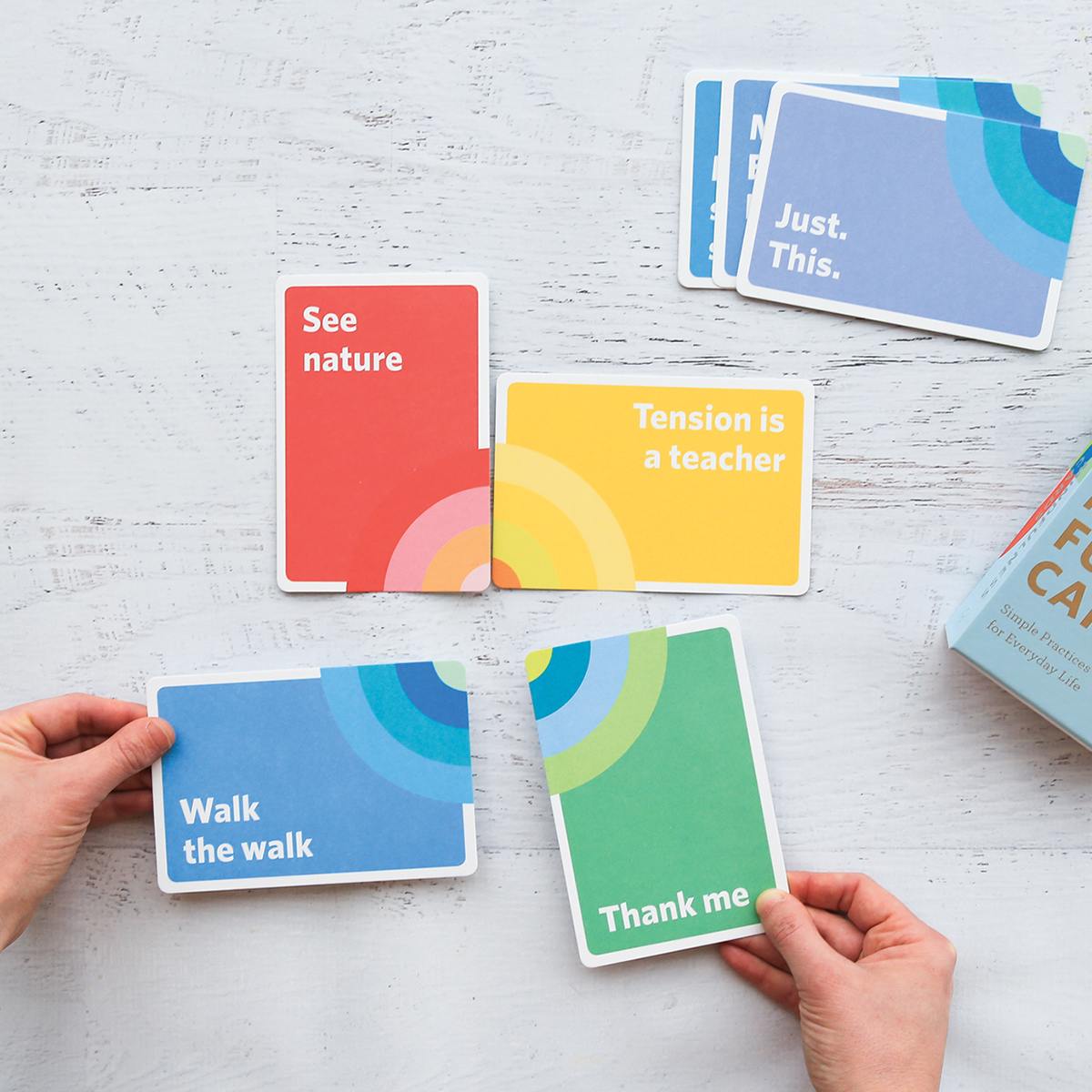 Mindfulness Cards - Hand fitting two cards with two others  
