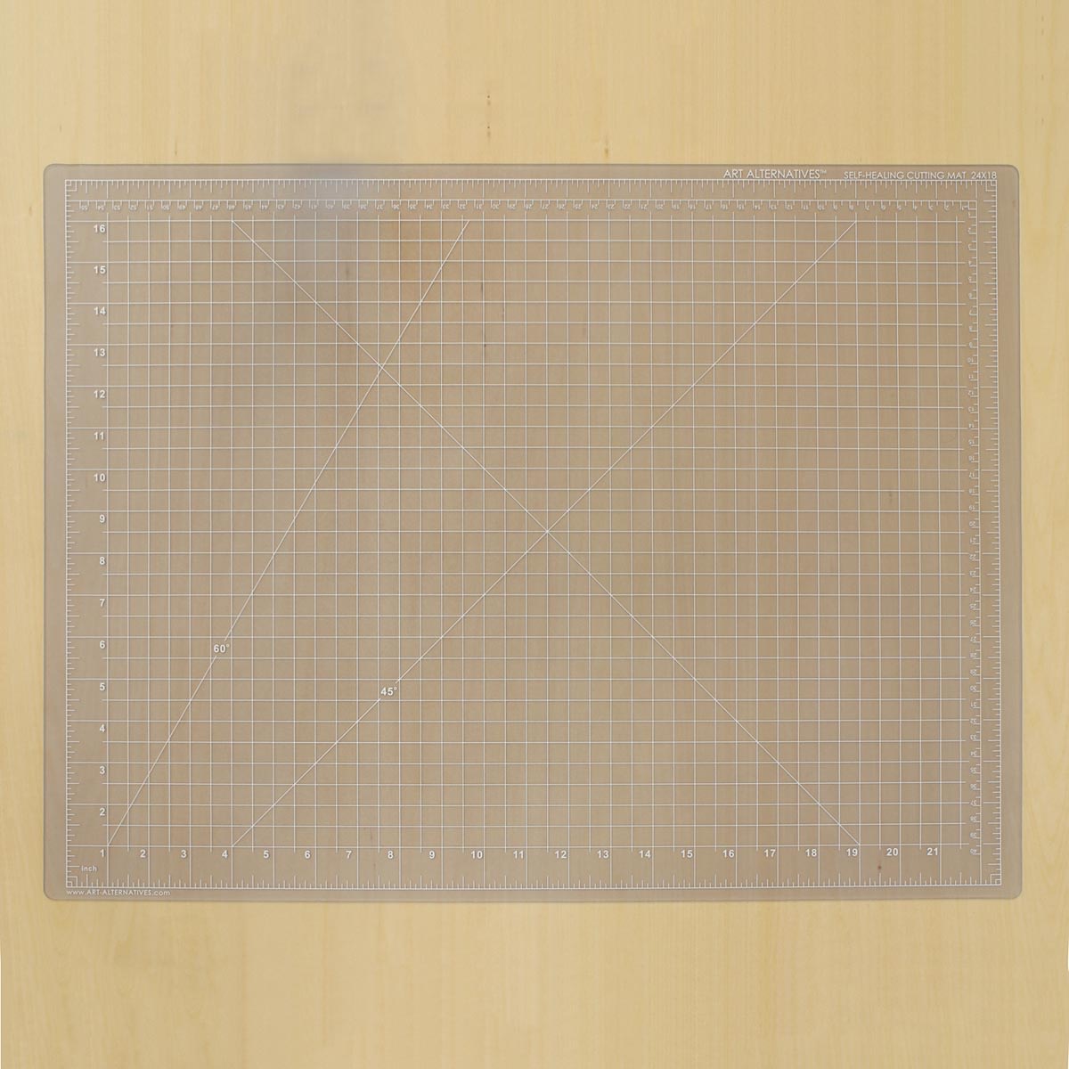 Art Alternatives Self-Healing Cutting Mat - Clear, 18" x 24" laying on table
