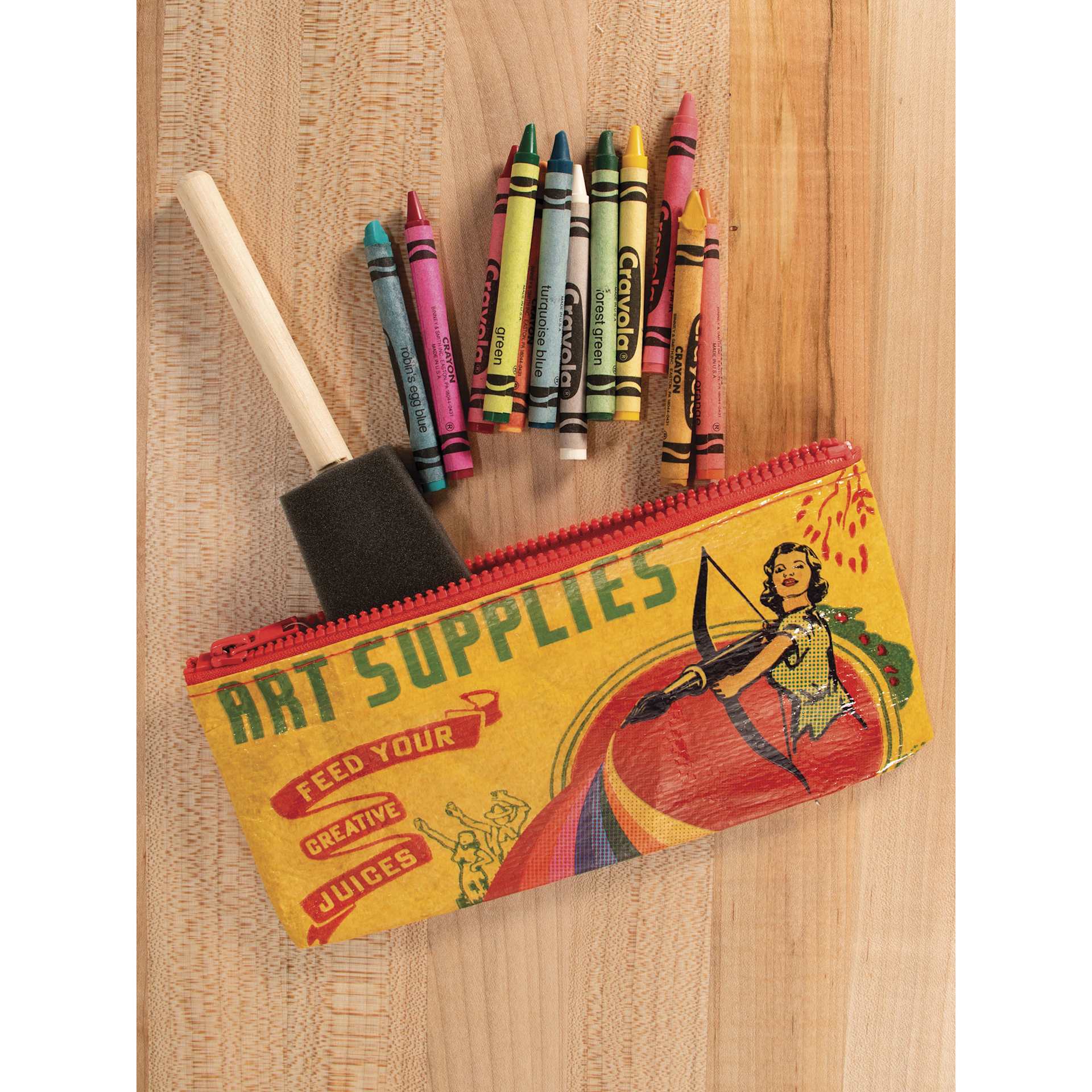 Blue Q Zipper Pencil Pouch - Art Supplies, 8-1/2" x 4-1/4", on table with art supplies (not included)