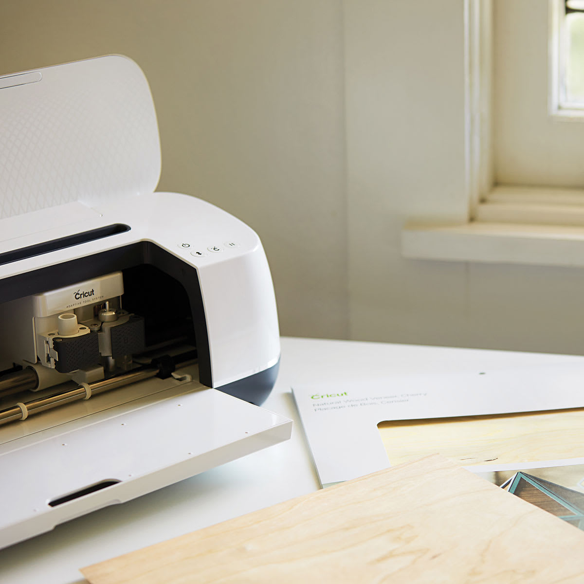 Cricut Wood Veneer - Angled view of Cutting machine with Veneer sheets