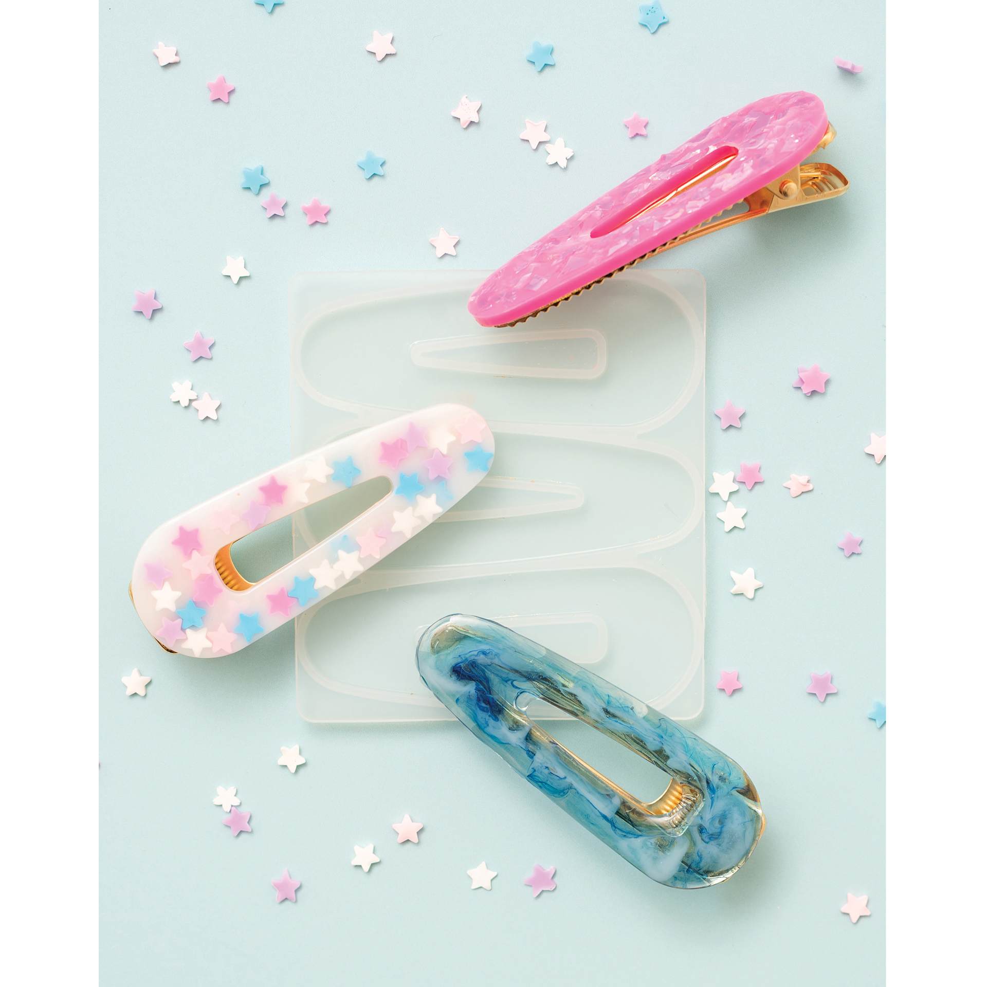 American Crafts Color Pour Resin Barrette Mold Kit showing mold with completed projects of assorted colors