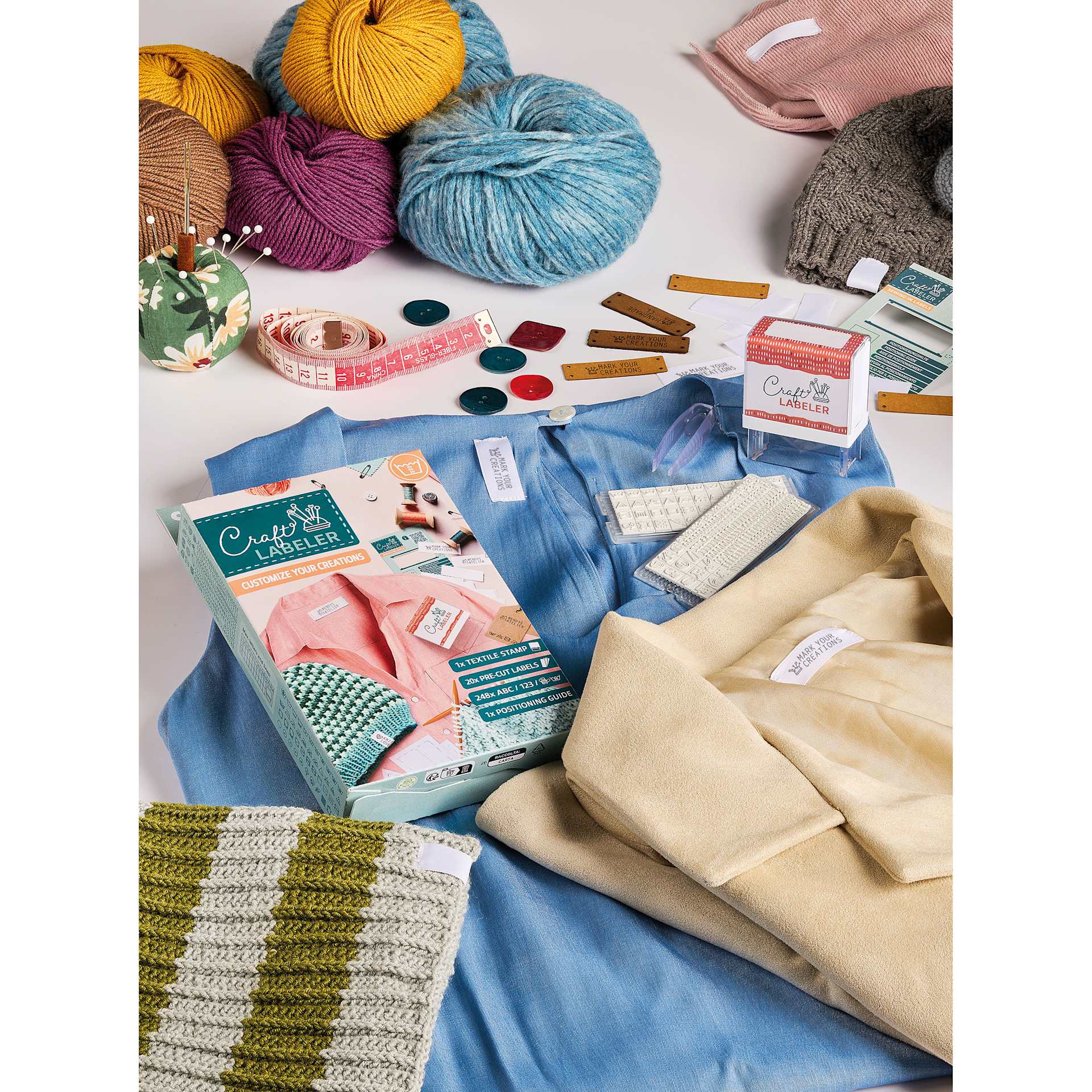 Colop Craft Labeler Textile Stamp Set laid out on table with other textile craft items