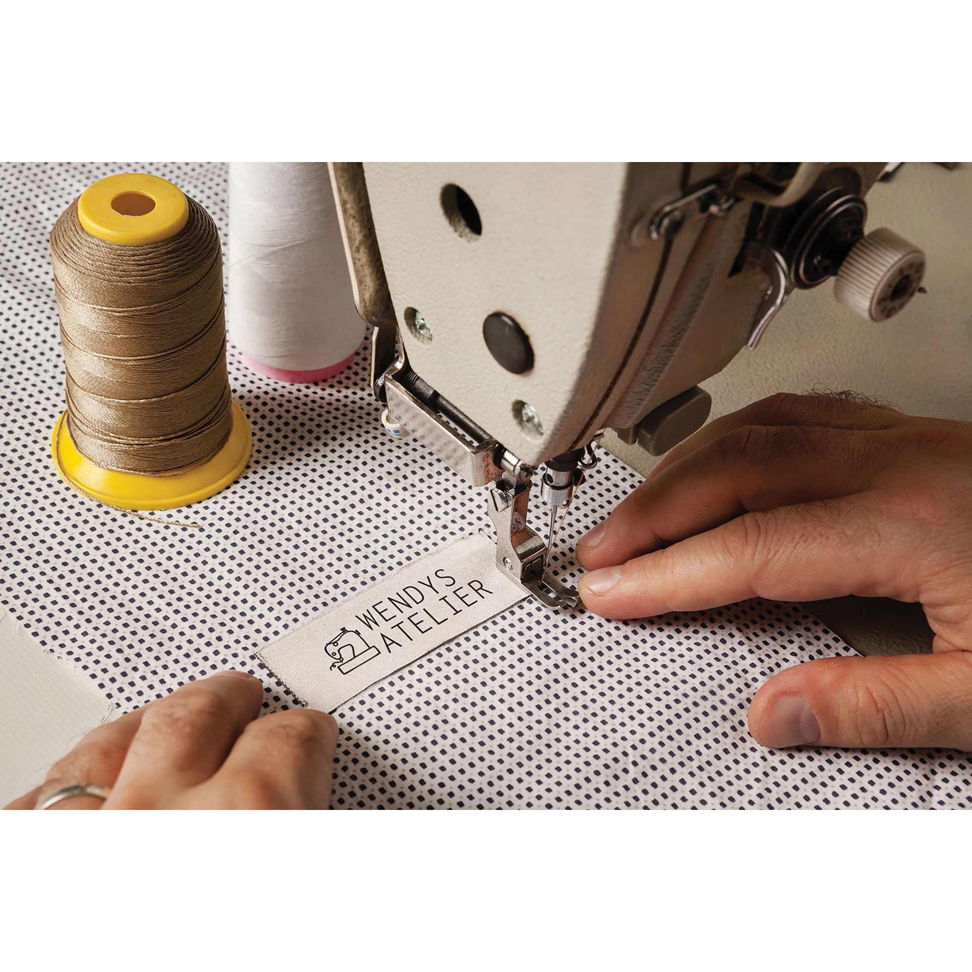 Colop Craft Labeler Sew-In Labels - Pkg of 40, 1.97" x .79" being sewed to cloth