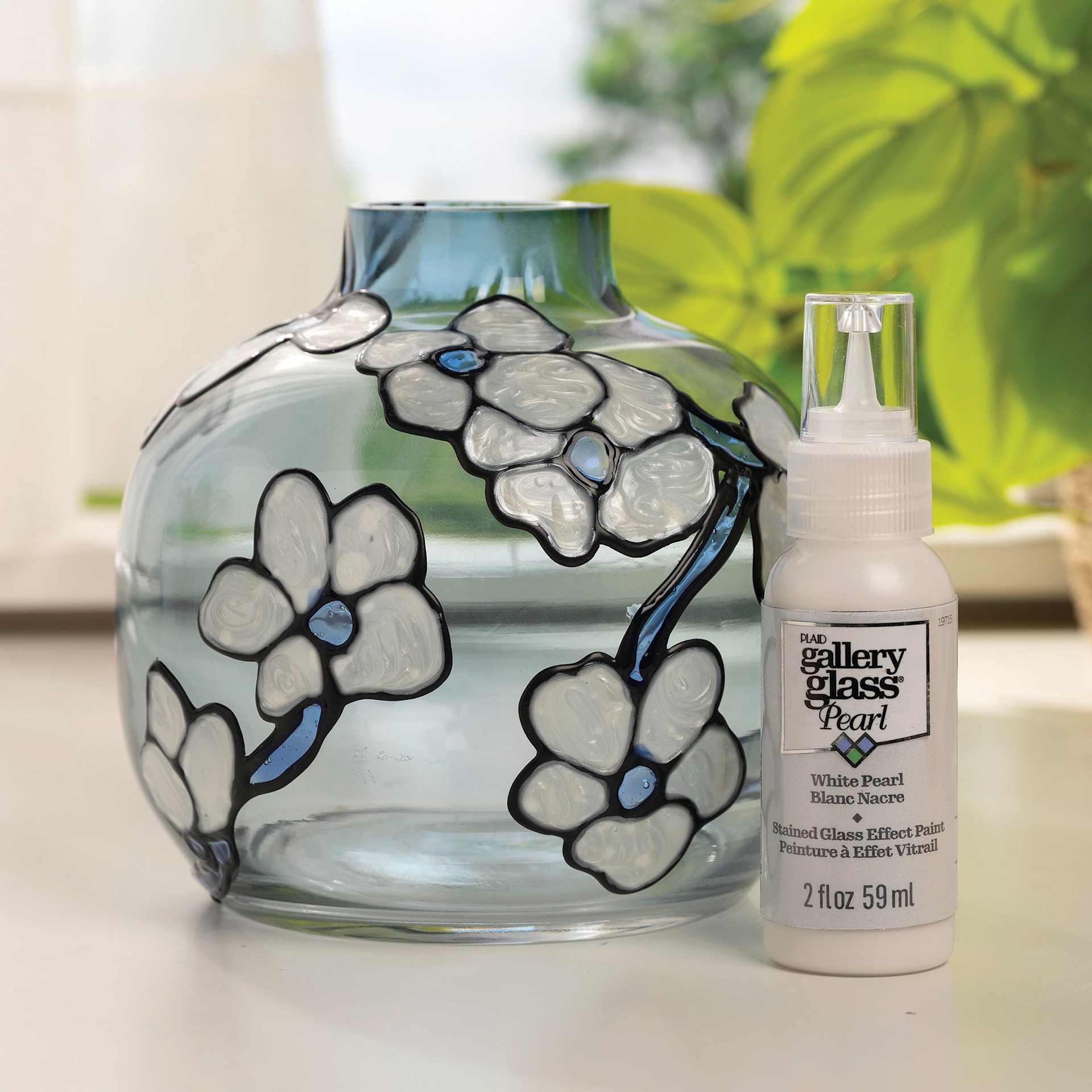 Gallery Glass Paint bottle and decorated blue vase.