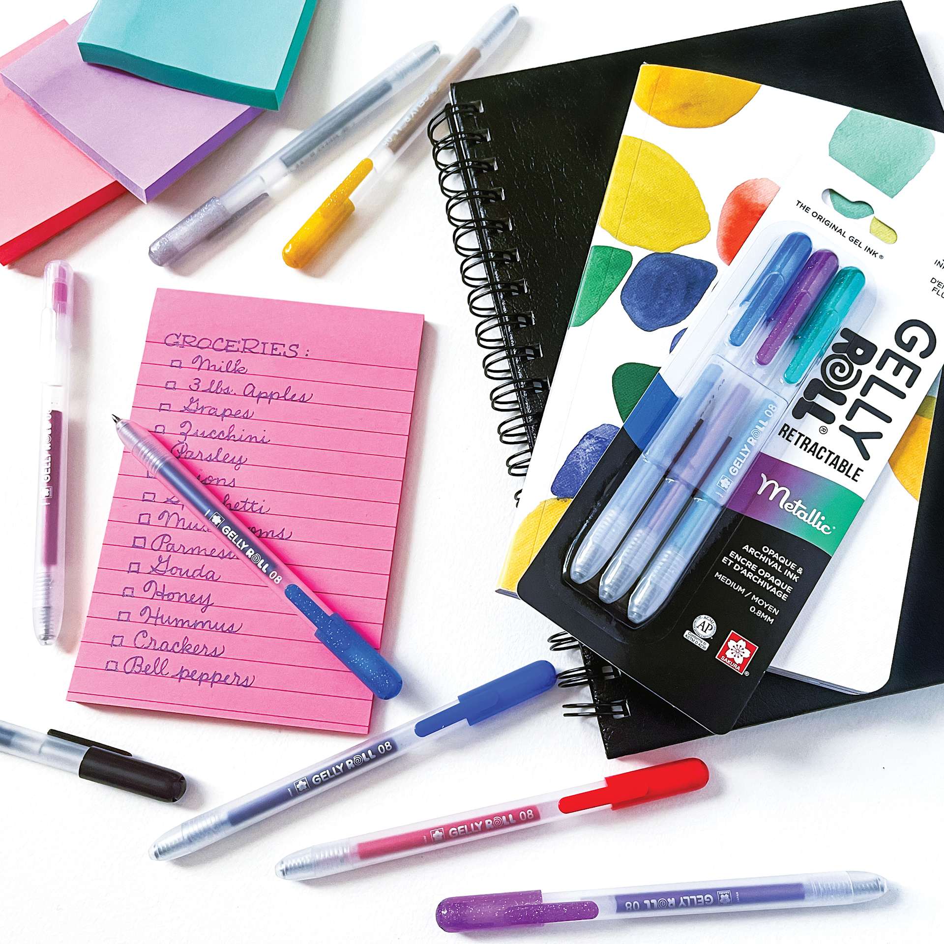 Sakura Gelly Roll Retractable Metallic Pens - Assorted, Medium Tip, Set of 3, on desk with other supplies (not included)