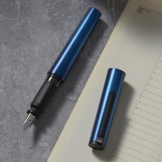 Sailor TUZU Adjust Fountain Pen - Metallic Blue, Fine, pen and cap resting on tabletop with stationary.