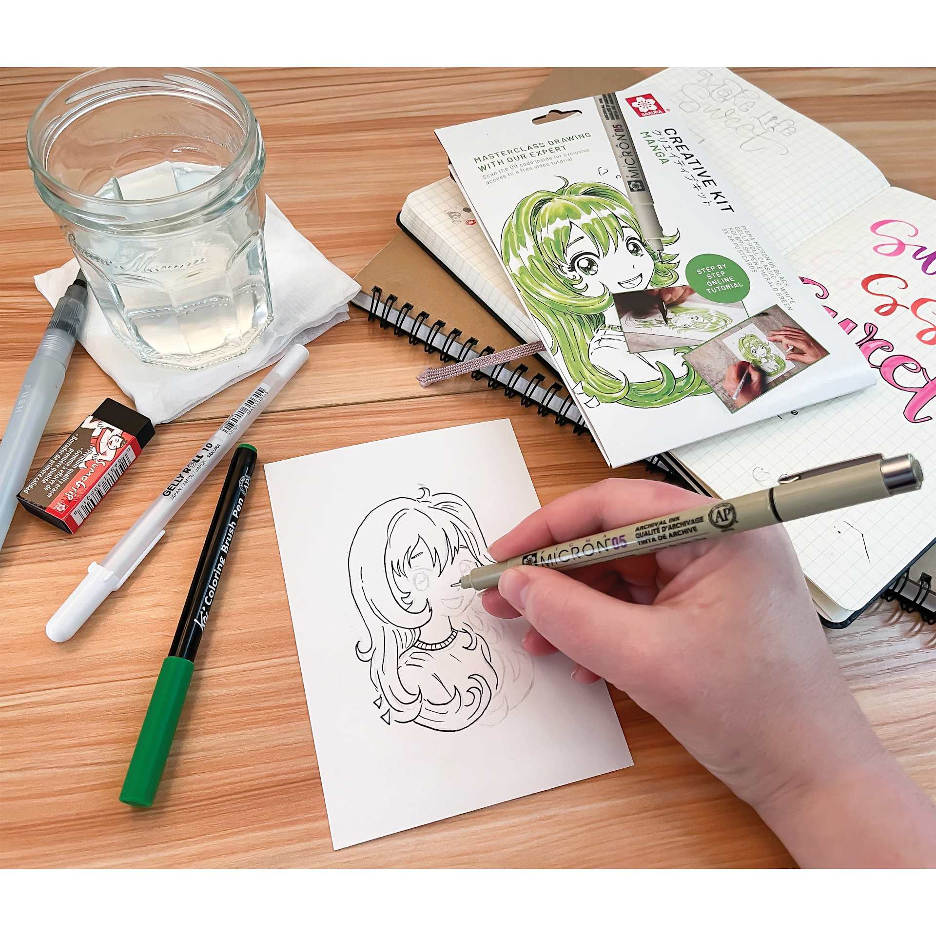 Sakura Creative Kit - Manga, contents shown on table and Pigma Micron in hand