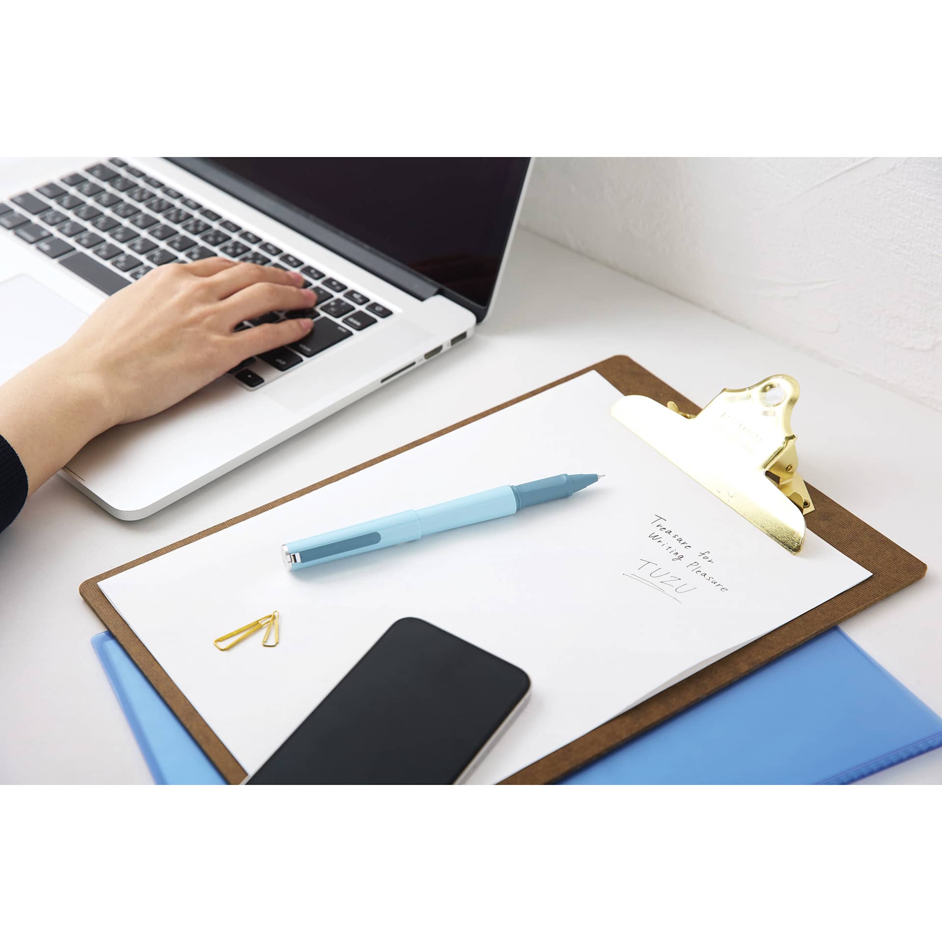 Sailor Tuzu Ballpoint Pen - Light Blue pen resting on clipboard