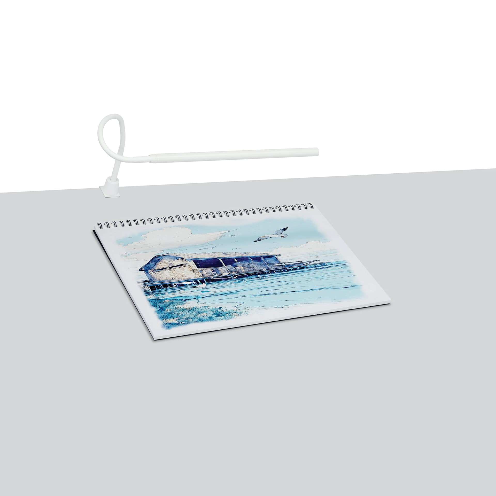 Artograph Bar Lamp with Table Clamp shown with artwork on desk