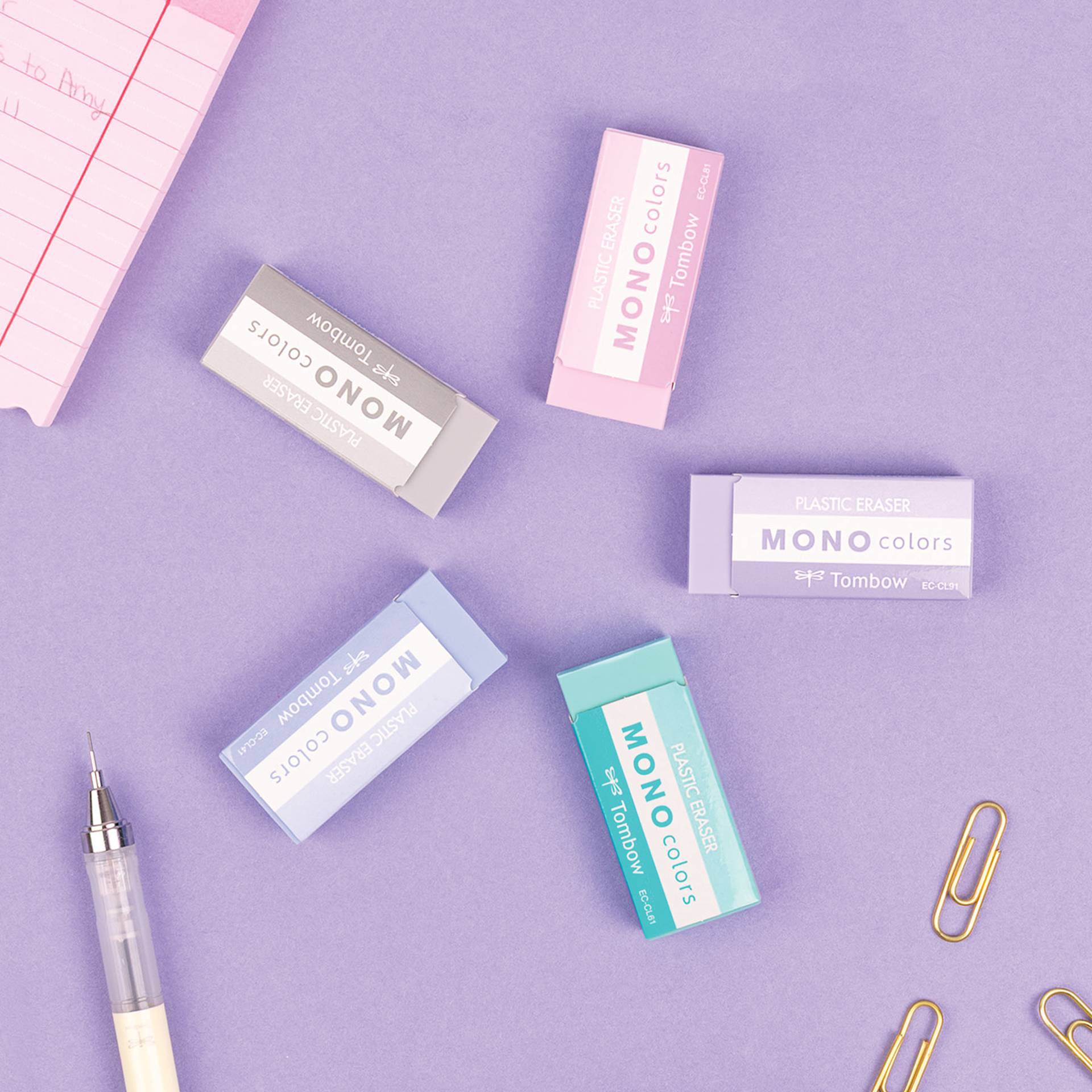 Tombow Mono Colors Erasers, available colors against a purple background with stationary supplies