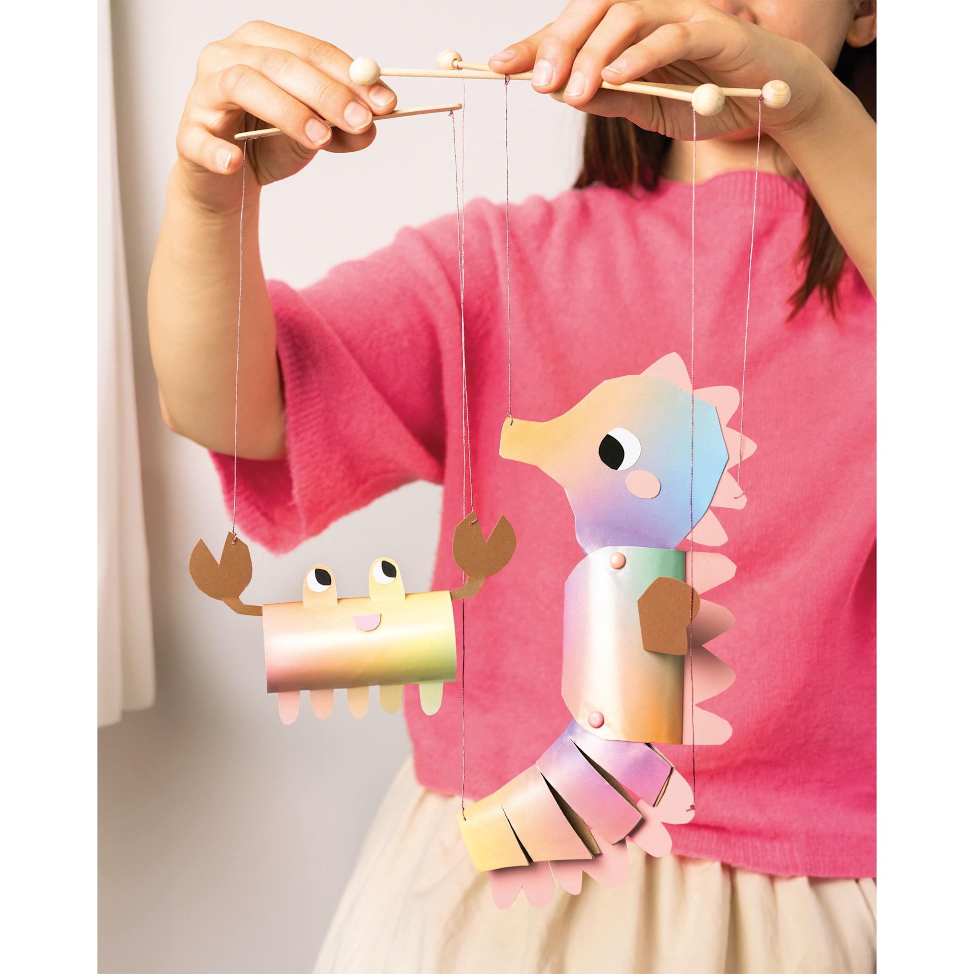 Folia Decorative Paper - 8.9" x 12.6", Gloss Rainbow, 10 Sheets, child holding crab and seahose made with paper.
