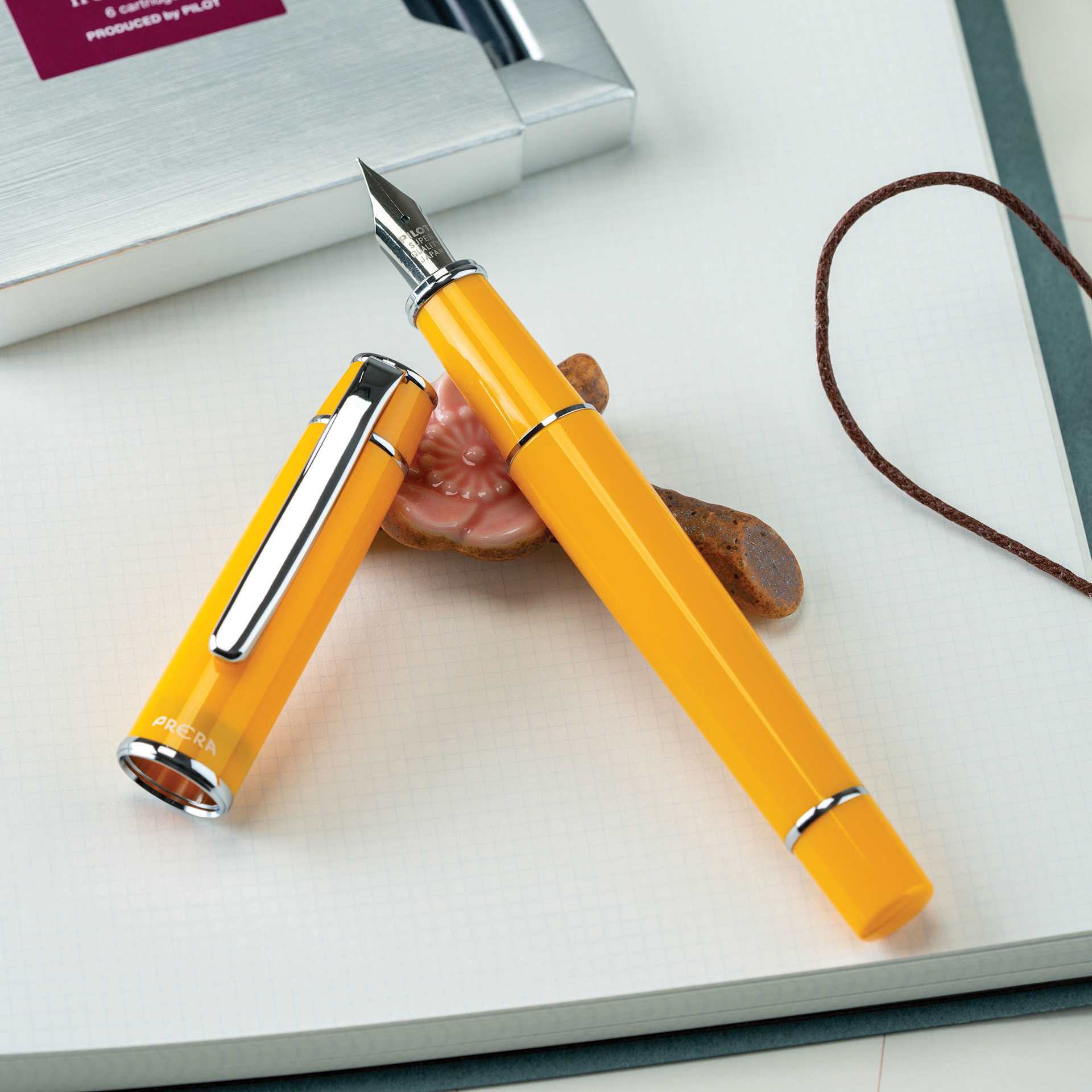 Pilot Prera Standard Fountain Pen - Honey Yellow, Medium, cap off on paper pad (not included)