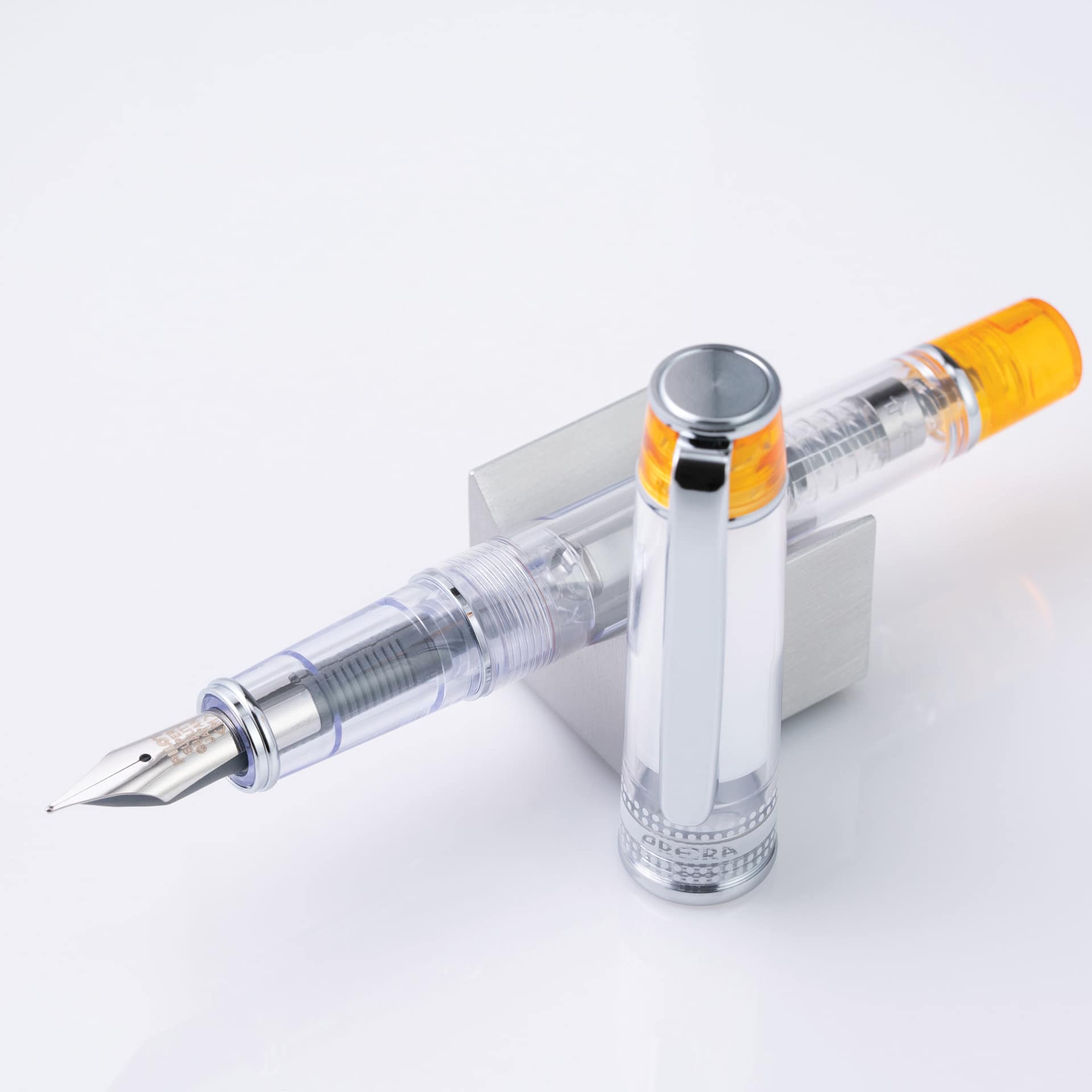 Pilot Prera Clear Fountain Pen - Orange, Calligraphy Nib, on stand (image may depict a different style nib)