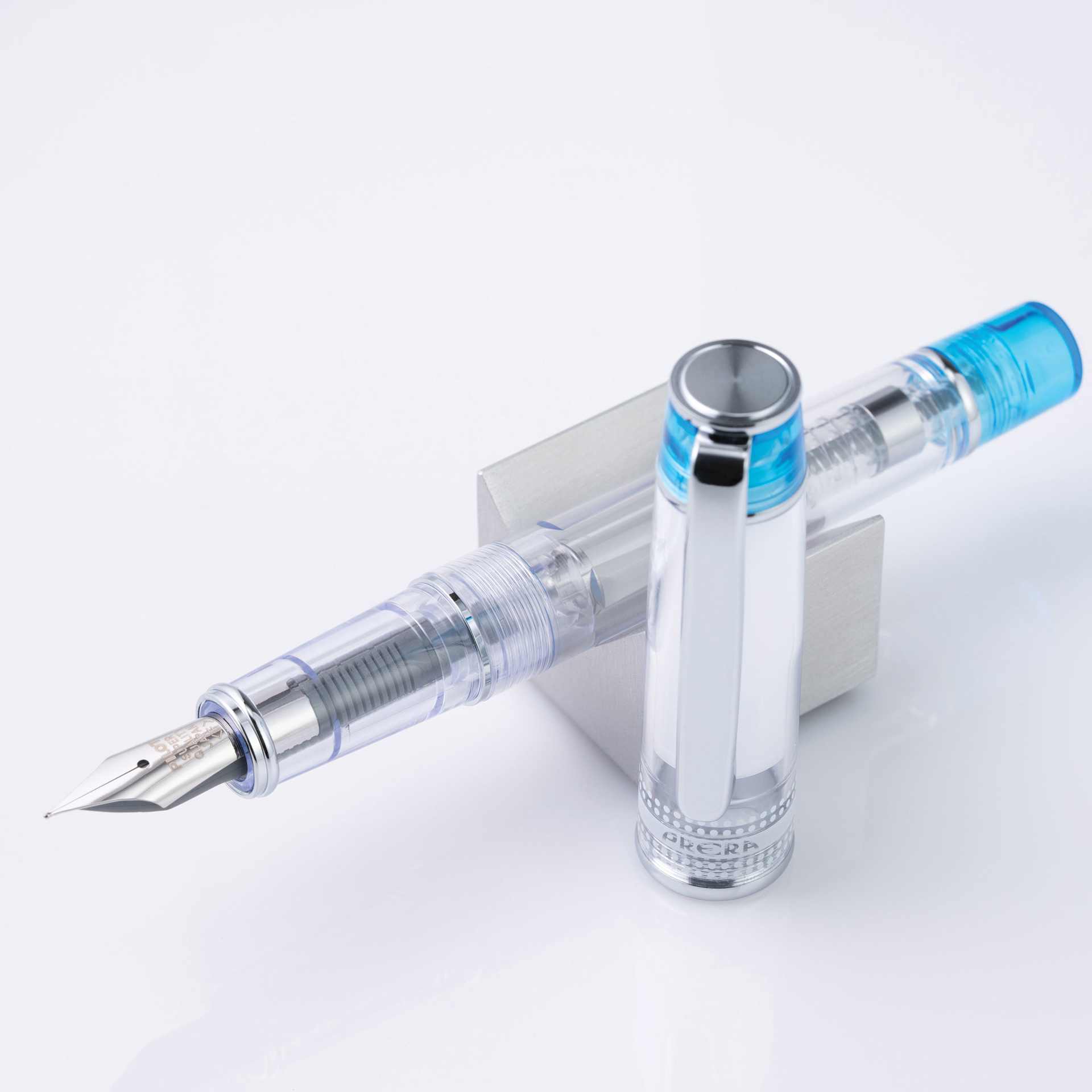 Pilot Prera Clear Fountain Pen - Light Blue, Medium Nib, on stand (image may depcit a different style nib)
