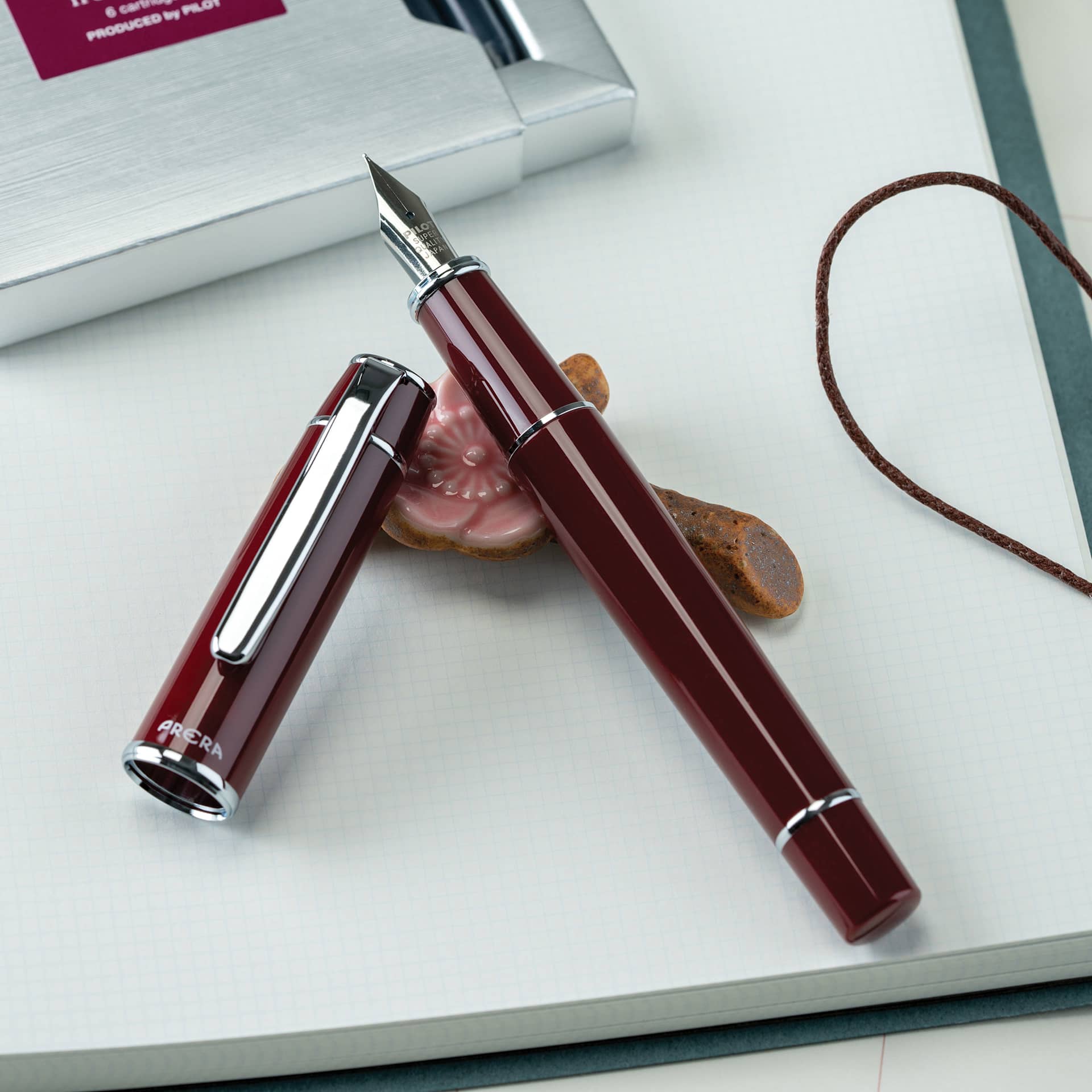 Pilot Prera Standard Fountain Pen - Cinnamon Brown, Fine, cap off on paper pad (not included)