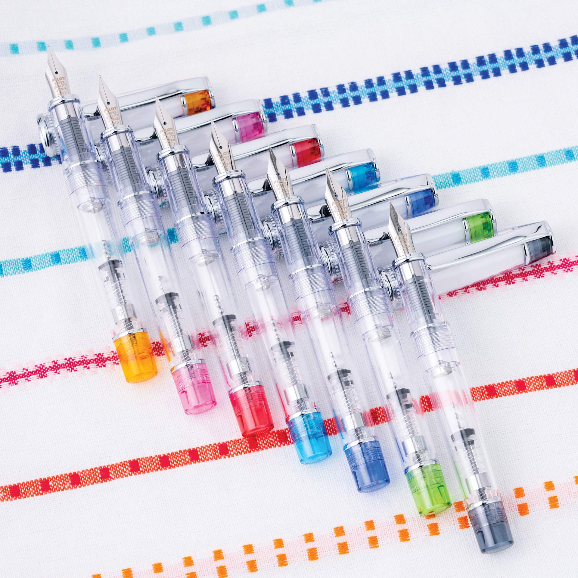 Pilot Prera Clear Fountain Pens, on colorful tablecloth