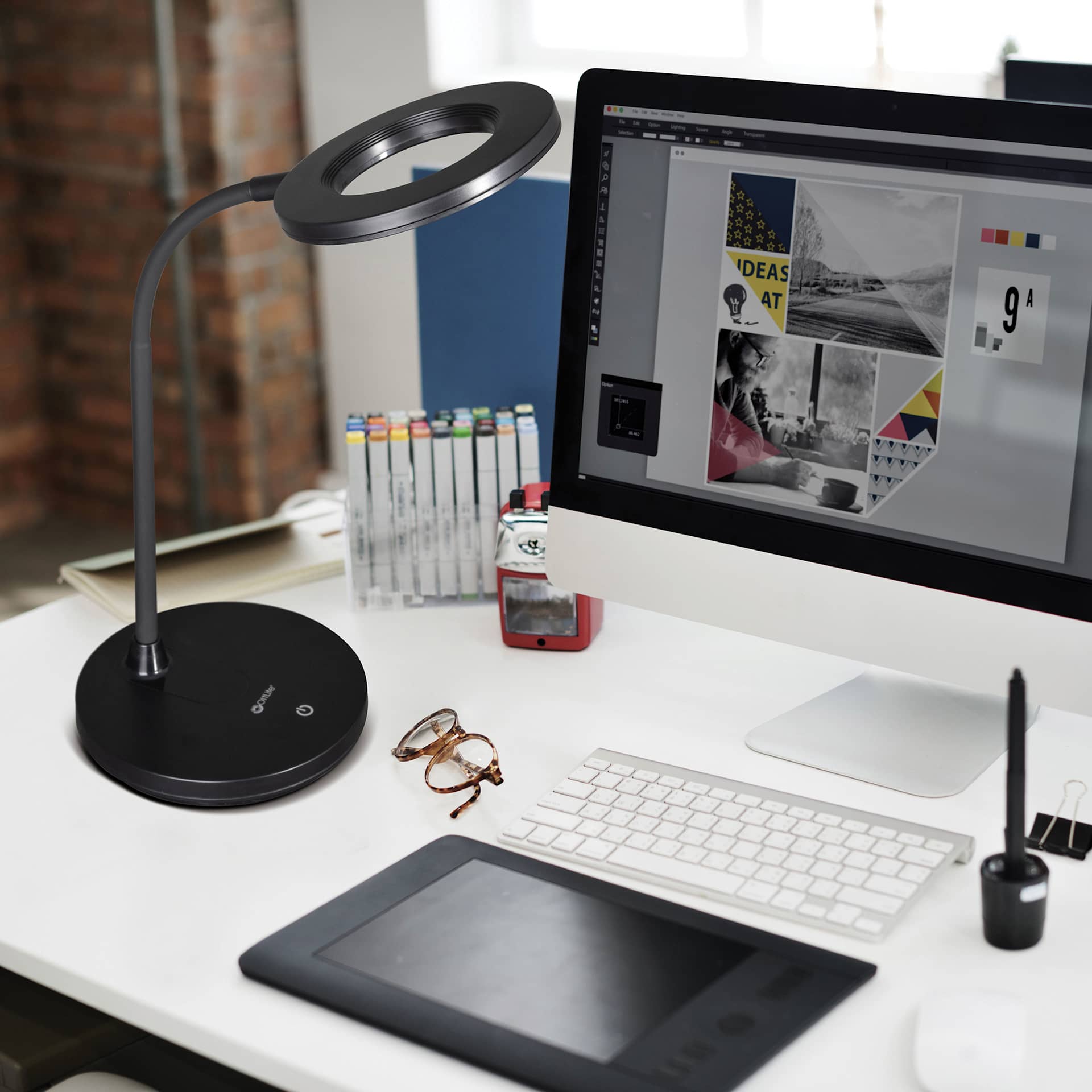 OttLite Vibe Rechargeable LED Ring Light - on the left of a desk top computer