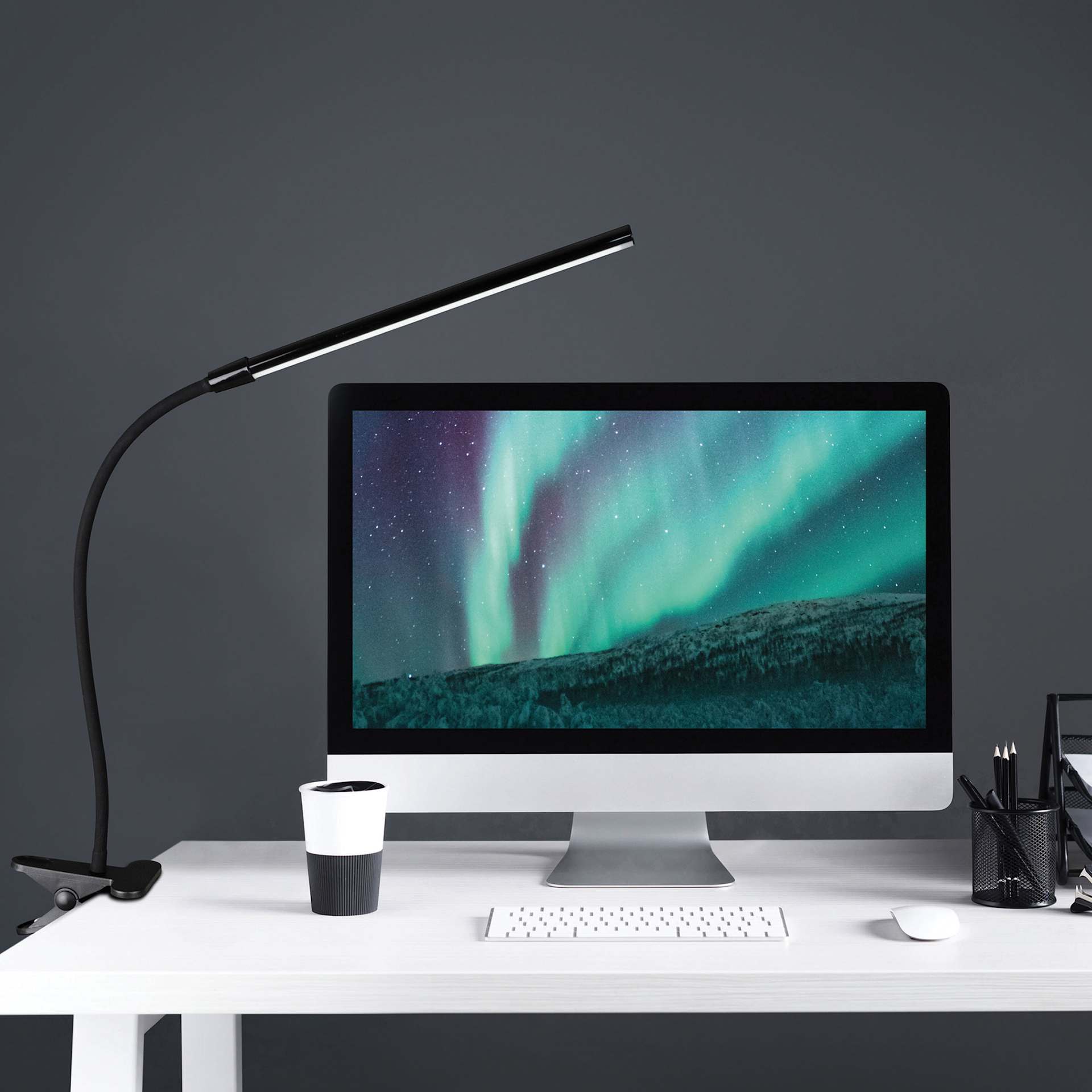 OttLite Clip-On LED Easel Lamp - Black, on a desk with a computer