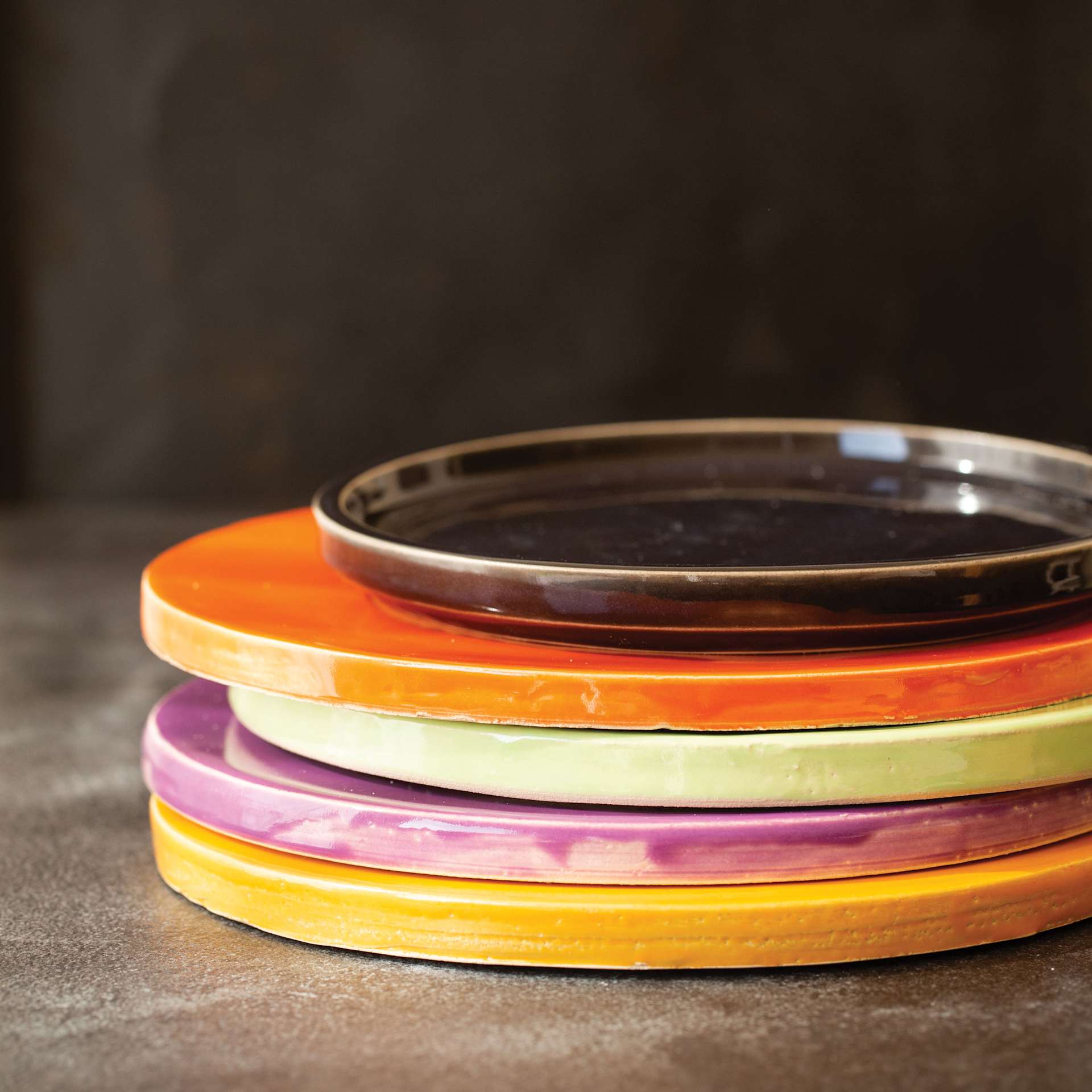Botz Pro Glazes finished large ceramic circle examples stacked on table