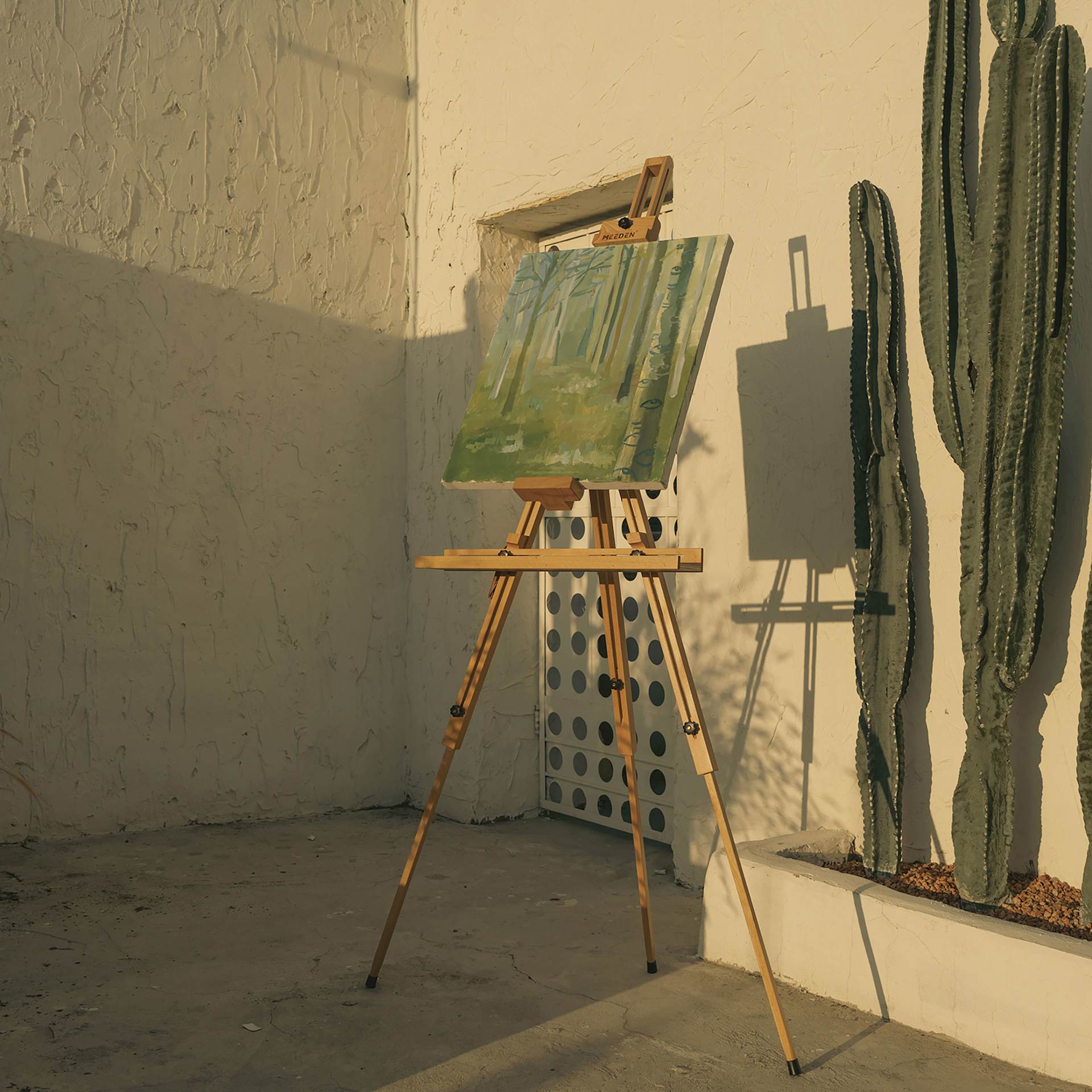 Meeden Tripod Plein Air Easel - 32” W x 35” D, 51" - 76" H - holding canvas in courtyard
